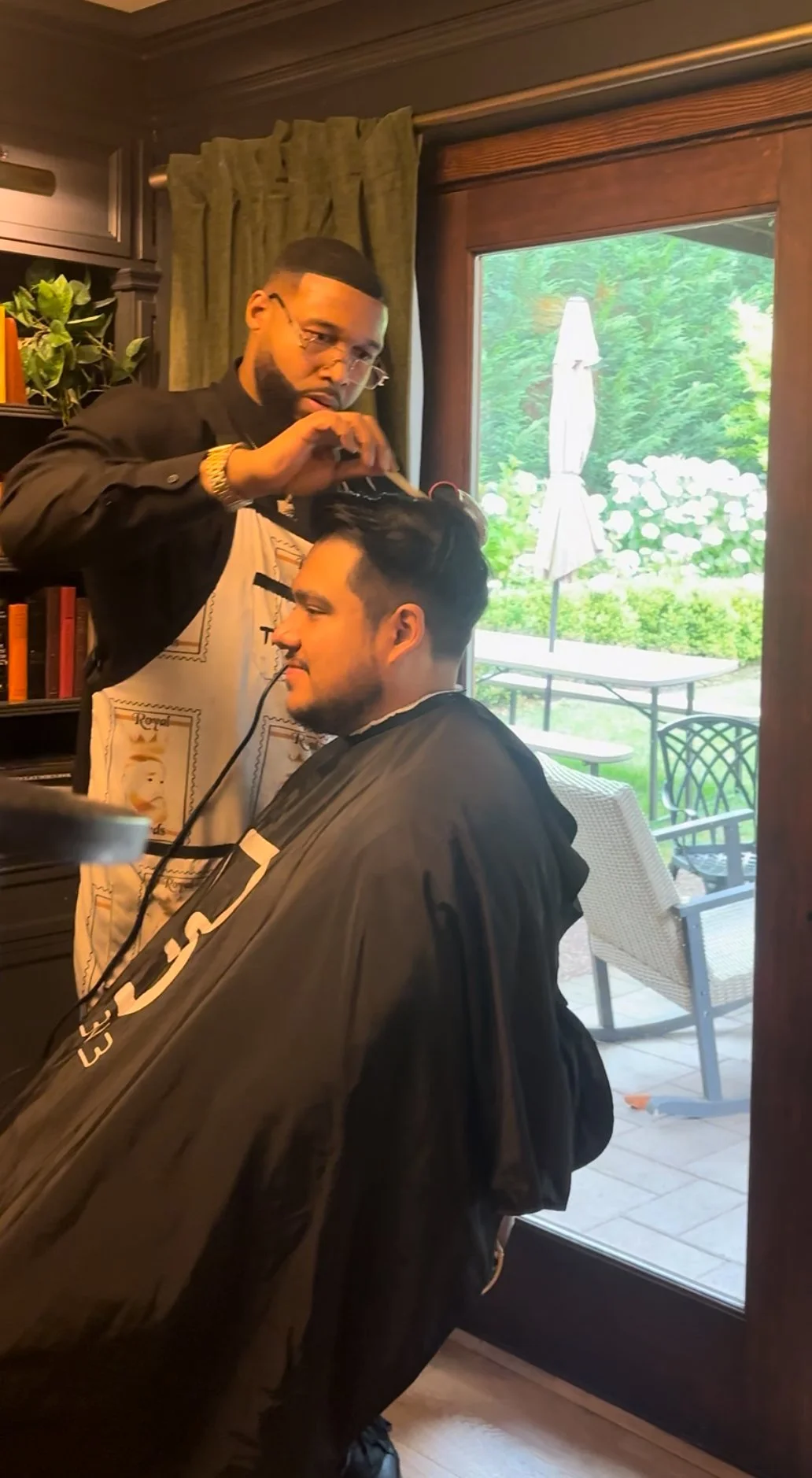 Groom receiving on-location grooming services on wedding day