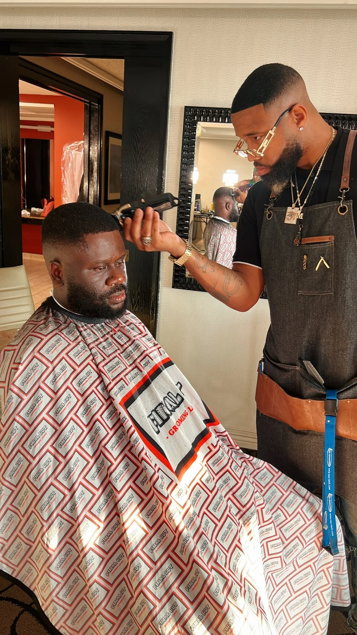 Groom receiving on-location grooming services on wedding day
