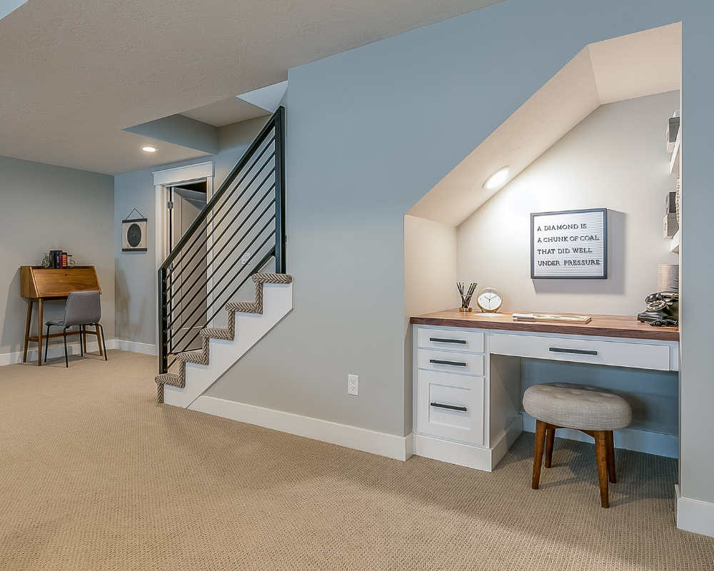 finished-basement-with-stairs-and-desk.png