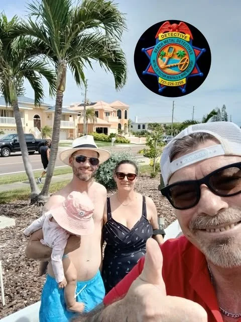 Group of four people outdoors near palm trees, with houses and a street in the background. One man is holding a small child with a pink hat. Everyone is smiling, and the man in the foreground is giving a thumbs-up. There is a police badge logo with neon colors and the words 'Detective' and contact information.