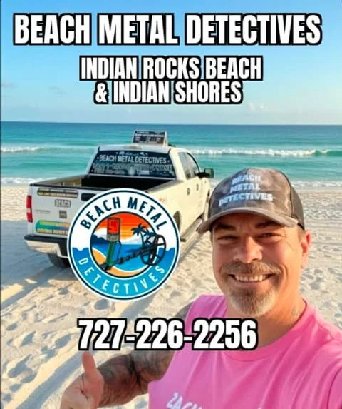 A man on the beach wearing a cap and pink shirt, smiling and giving a thumbs-up. Behind him is a pickup truck with a Beach Metal Detectives logo on the door and a large sign on top. The background shows the ocean and blue sky. The image contains text advertising Beach Metal Detectives, Indian Rocks Beach, and Indian Shores, with a phone number 727-226-2256.