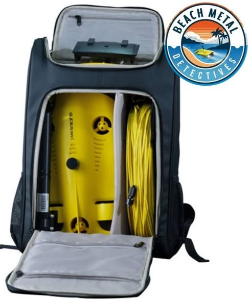 Open black backpack with yellow scuba diving equipment and a retractable yellow hose inside, and a Beach Metal Detectives logo in the top right corner.