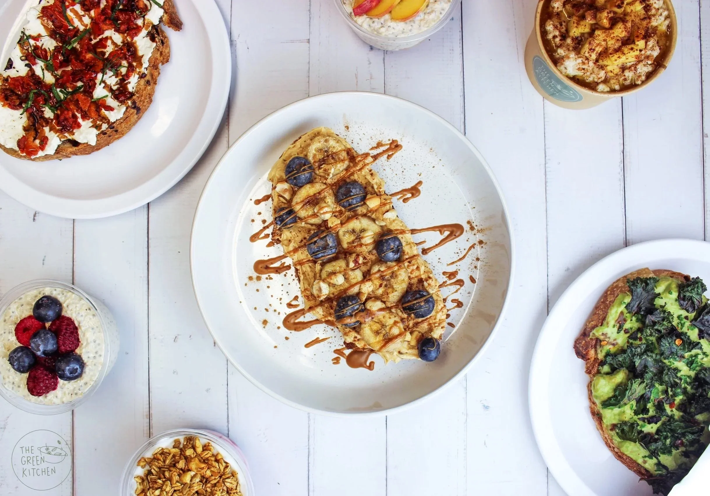 beautiful and bright breakfast bread of toast, vegan yoghurt, chia pudding and overnight oats, with fresh flavours, berries and delicious toppings
