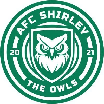 A circular green and white logo for AFC Shirley, featuring an owl with fierce eyes in the center, surrounded by the team name 'AFC Shirley' and the phrase 'The Owls', with the year 2021.