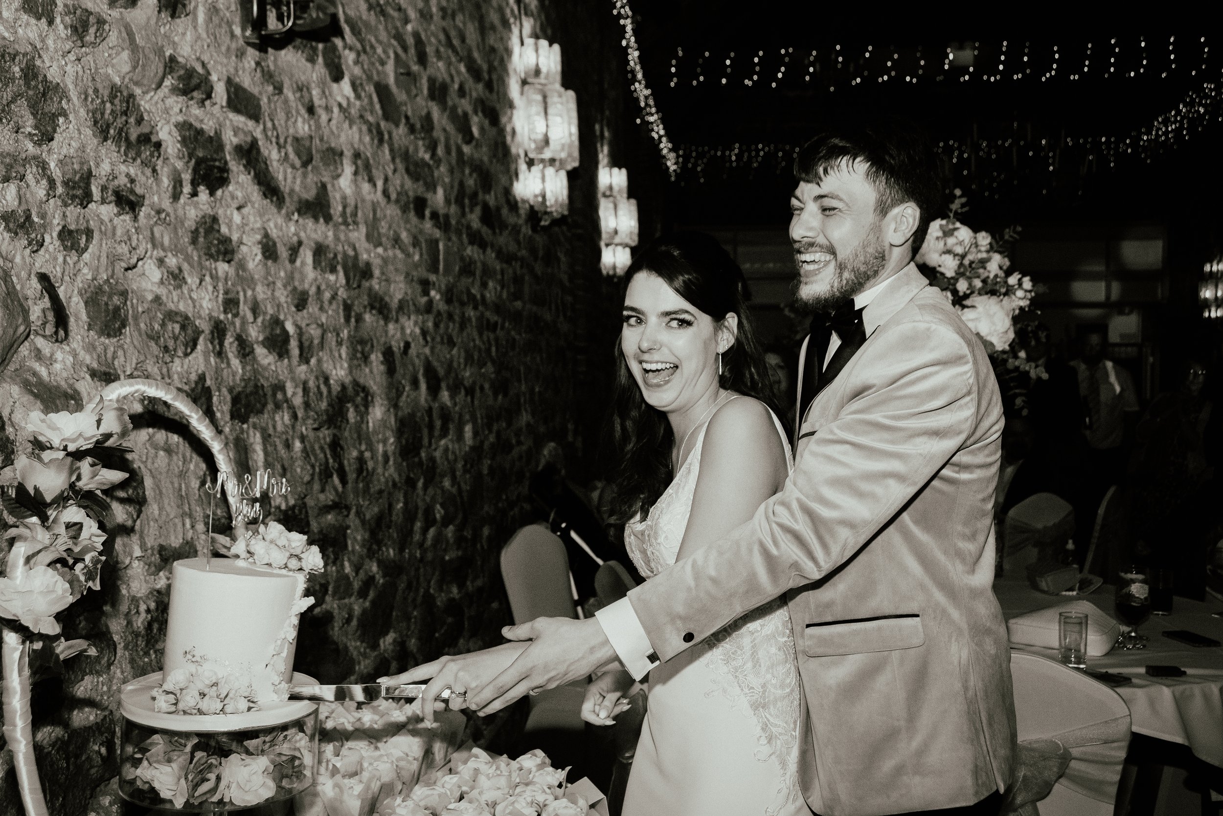 Relaxed documentary wedding photography capturing a couple cutting their cake during the reception. I am a wedding photographer based in Peterborough, Cambridgeshire, documenting natural moments throughout the wedding day.