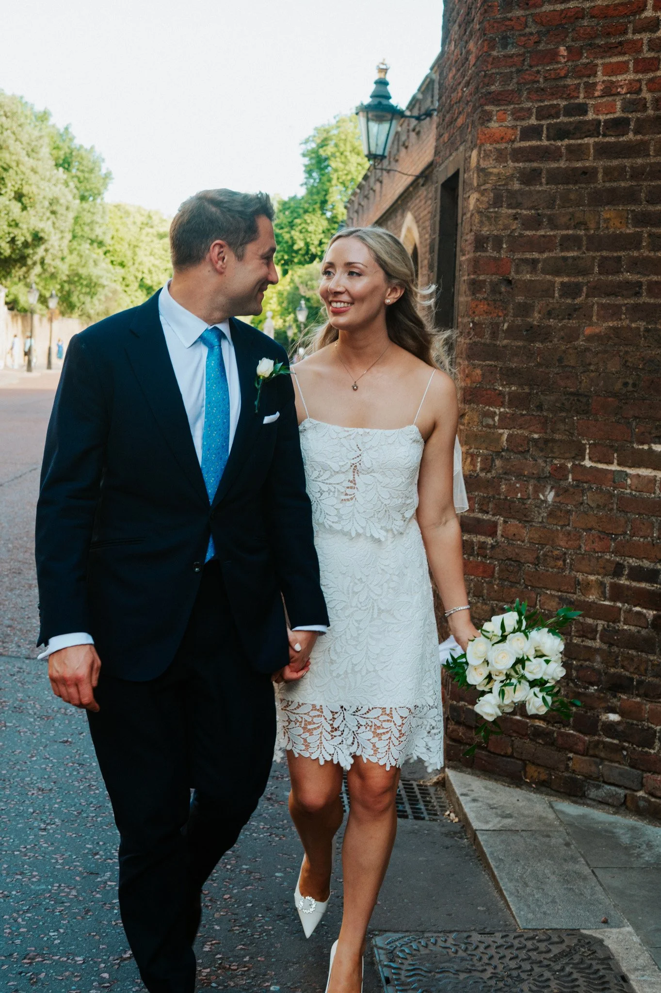 Bride and groom walking together after their wedding ceremony, captured in a documentary style. I am a wedding photographer based in Peterborough, Cambridgeshire, specialising in natural storytelling wedding photography.