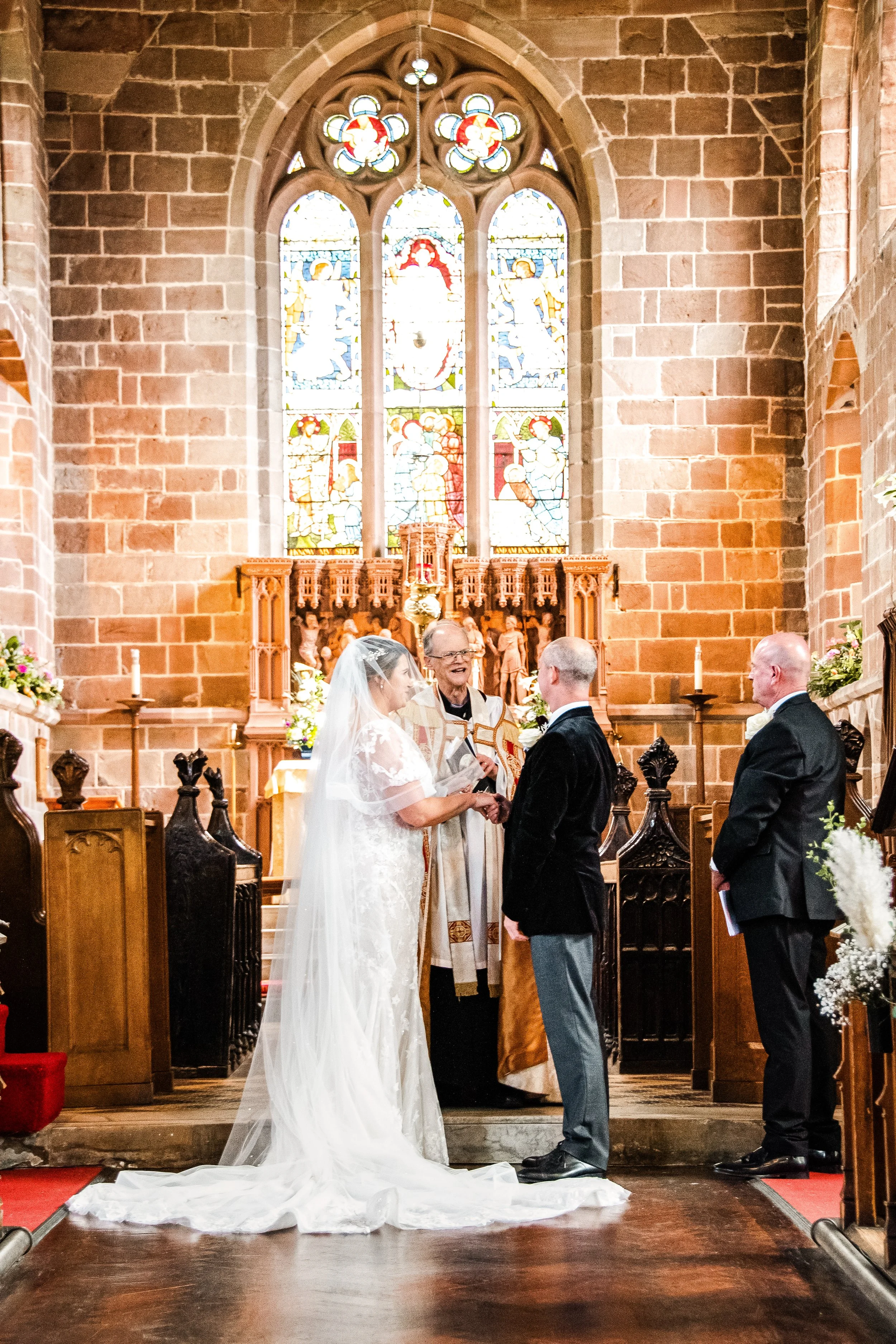 Bride and groom exchanging vows during a church wedding ceremony, captured in a natural documentary style. I am a wedding photographer based in Peterborough, Cambridgeshire, photographing meaningful moments as they unfold.