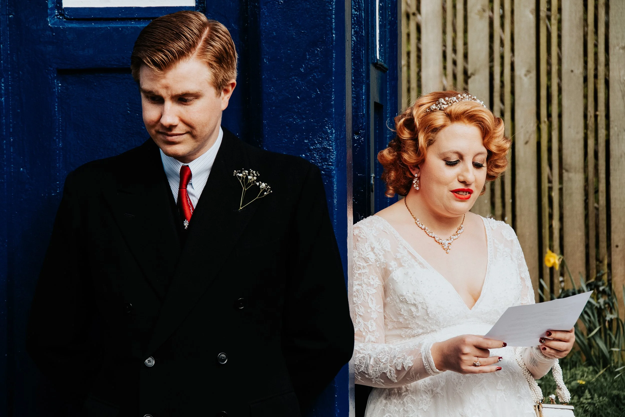 Documentary wedding photography capturing bride and groom reading vows, photographed by a Peterborough and Cambridgeshire wedding photographer.