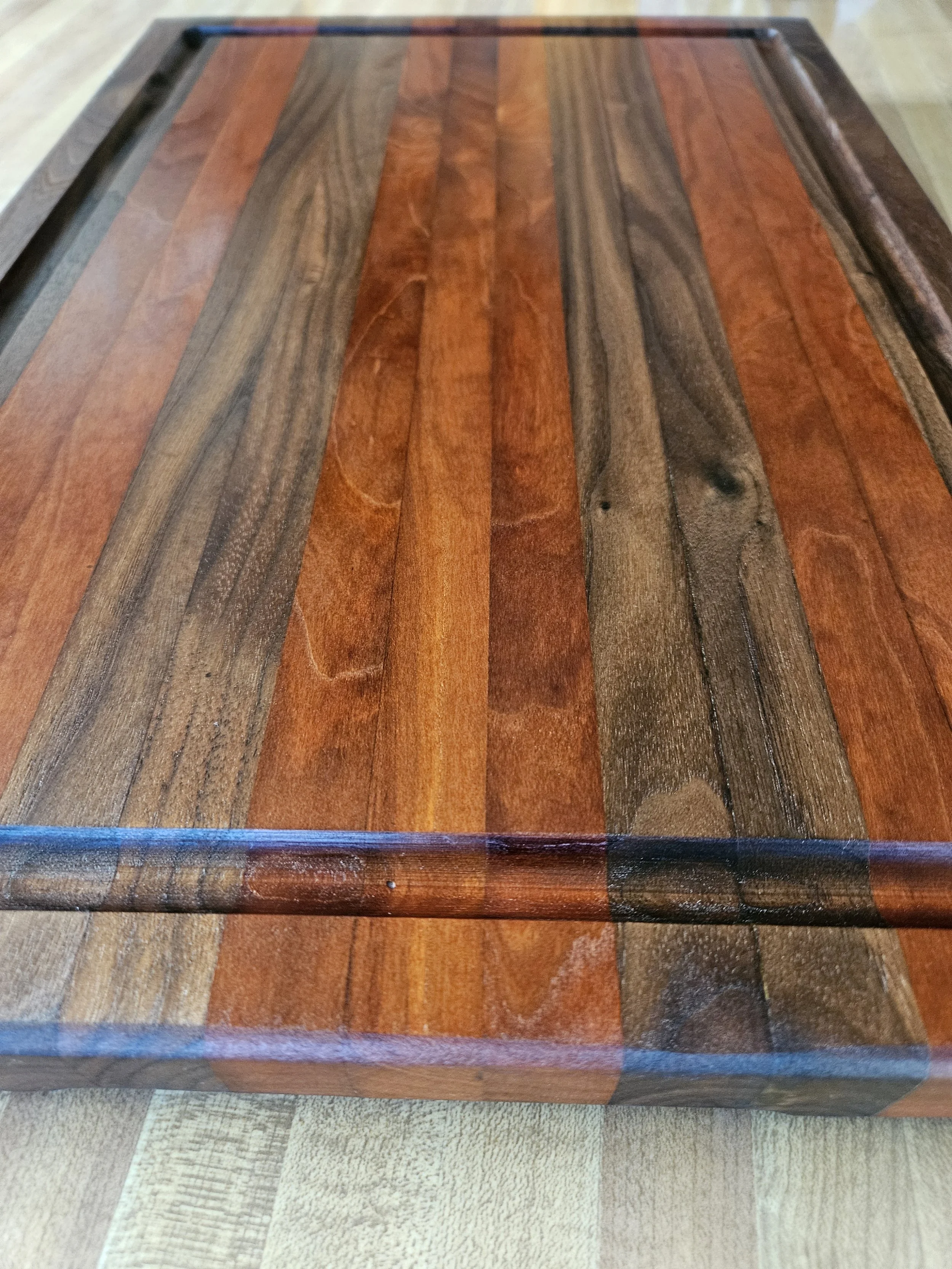 Close-up of a wooden table with a multicolored wood grain pattern.