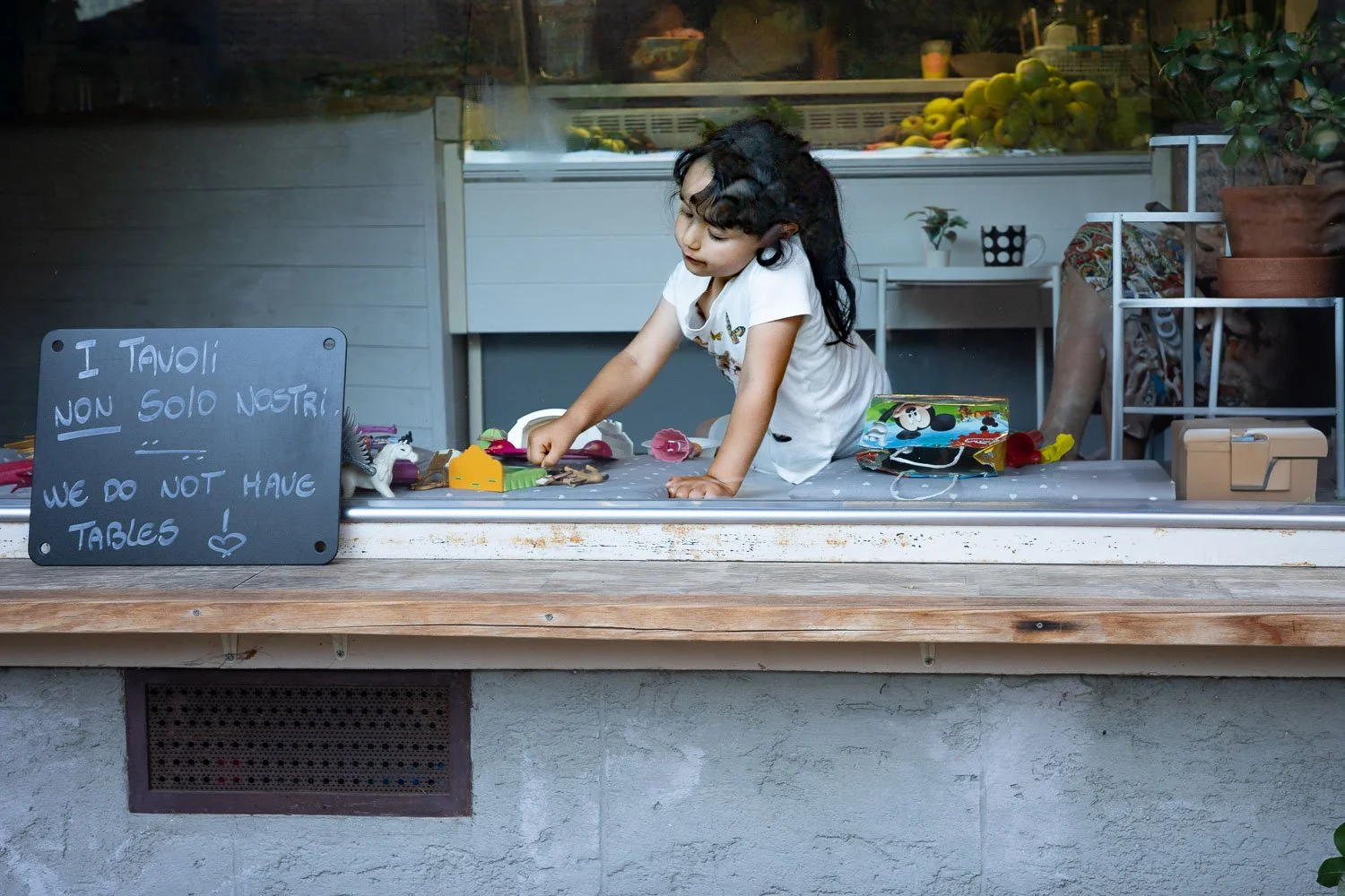 Girl at a store window, Gandria, 2025