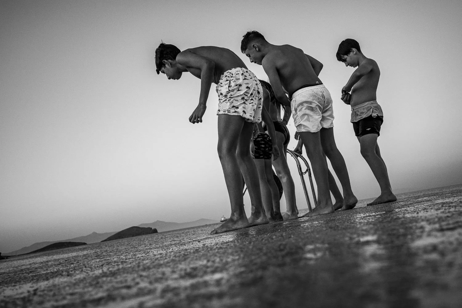 Boys looking at fish, Syros, 2025