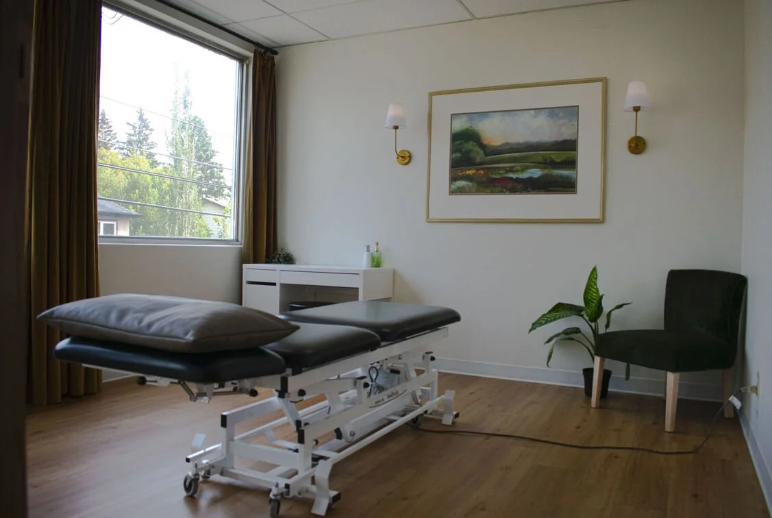 Ce Sport Therapy Clinic Treatment Room In Calgary with treatment table, green charm, warm and inviting