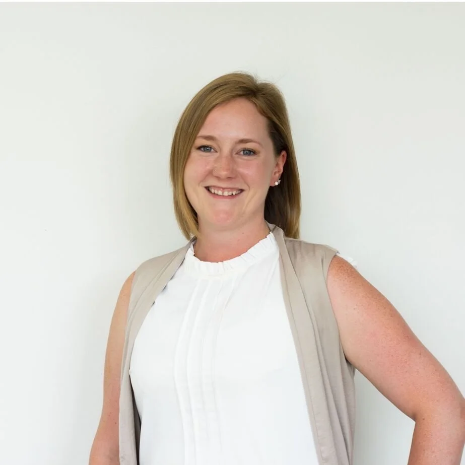Michelle Gaudet, Athletic Therapist in Calgary bio headshot standing in front of white background smiling