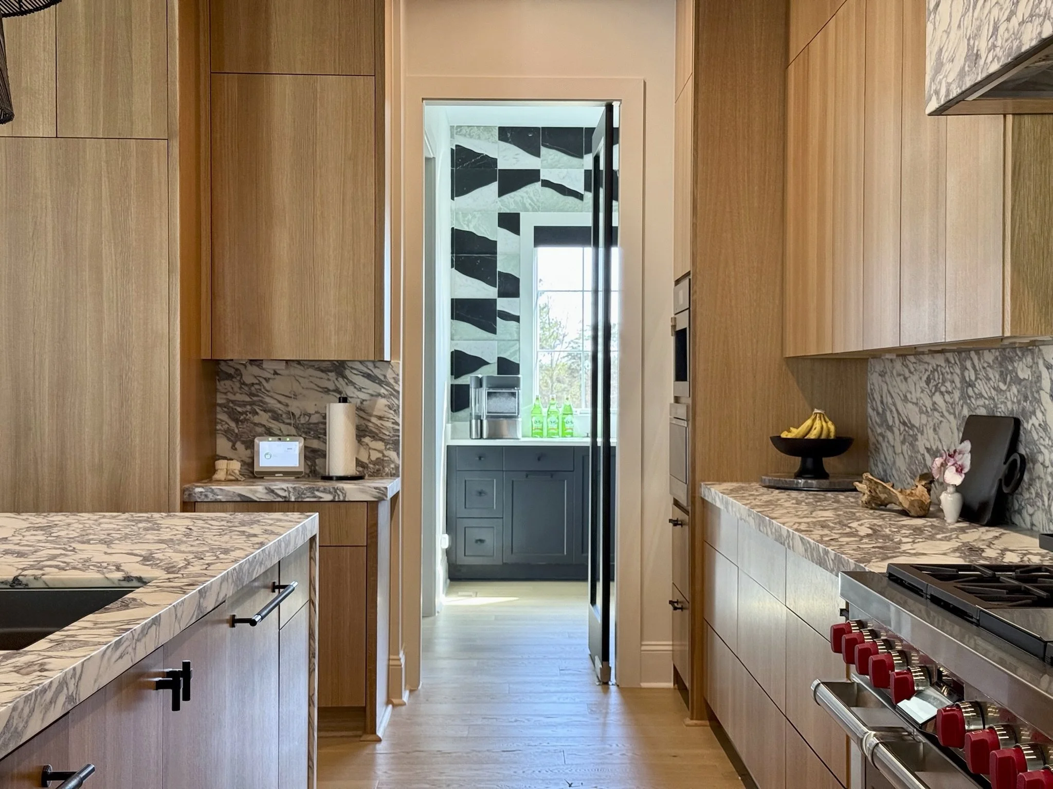 A view of the butler kitchen beyond, clad in Artistic Tile's extra dimensional stacks.