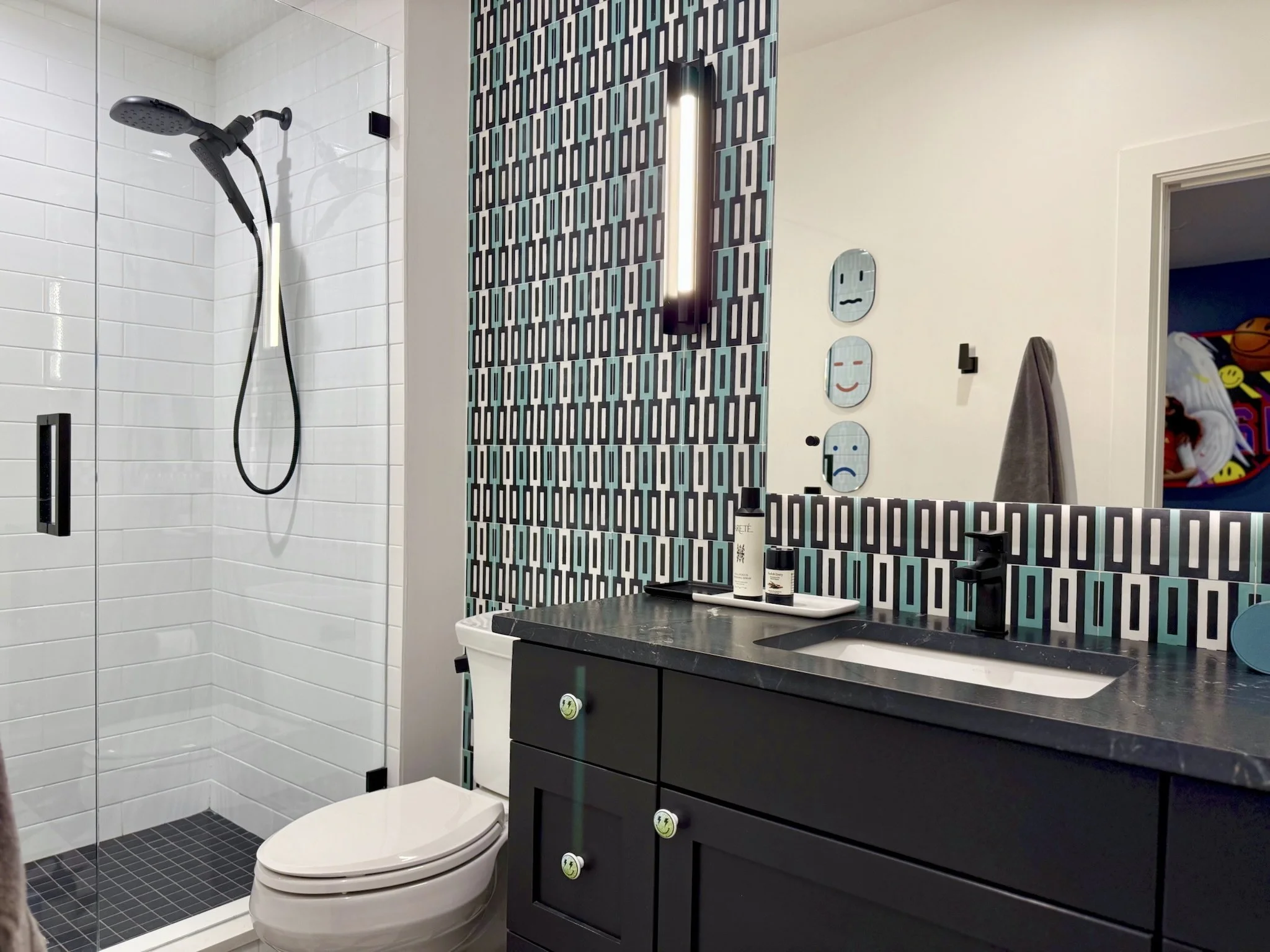 Owen’s Bath: A black-painted vanity paired with graphic floor tile turns a basic install into a bold statement.
Reid’s Bath: A lime green vanity and patterned tile keep the energy high while tying into the house’s black-and-white theme.

Boys’ Bedroo