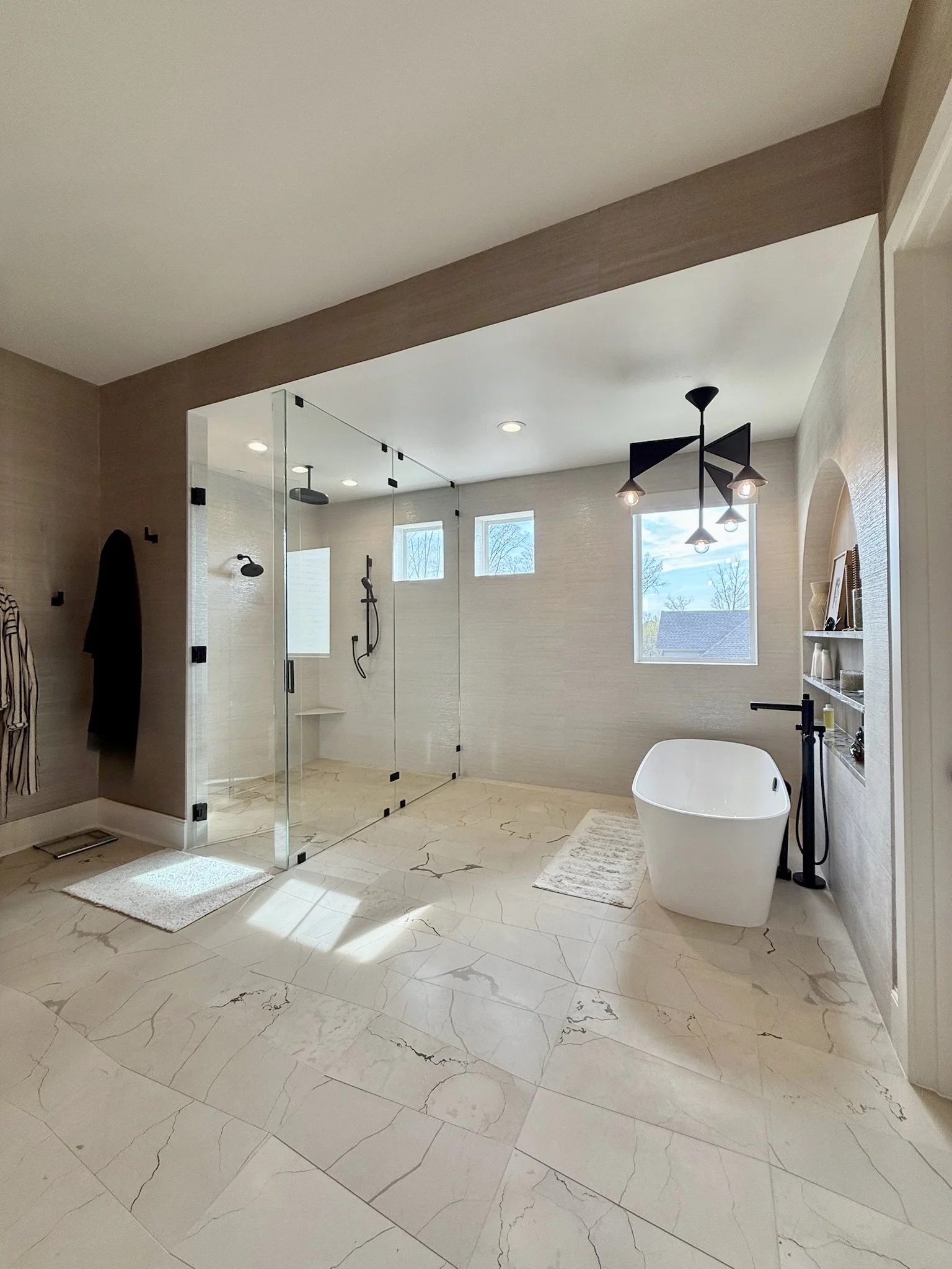 Custom Tile Flooring – Artistic Tile crafted the trapezoid-cut stone floor, a subtle geometric foundation for the space.