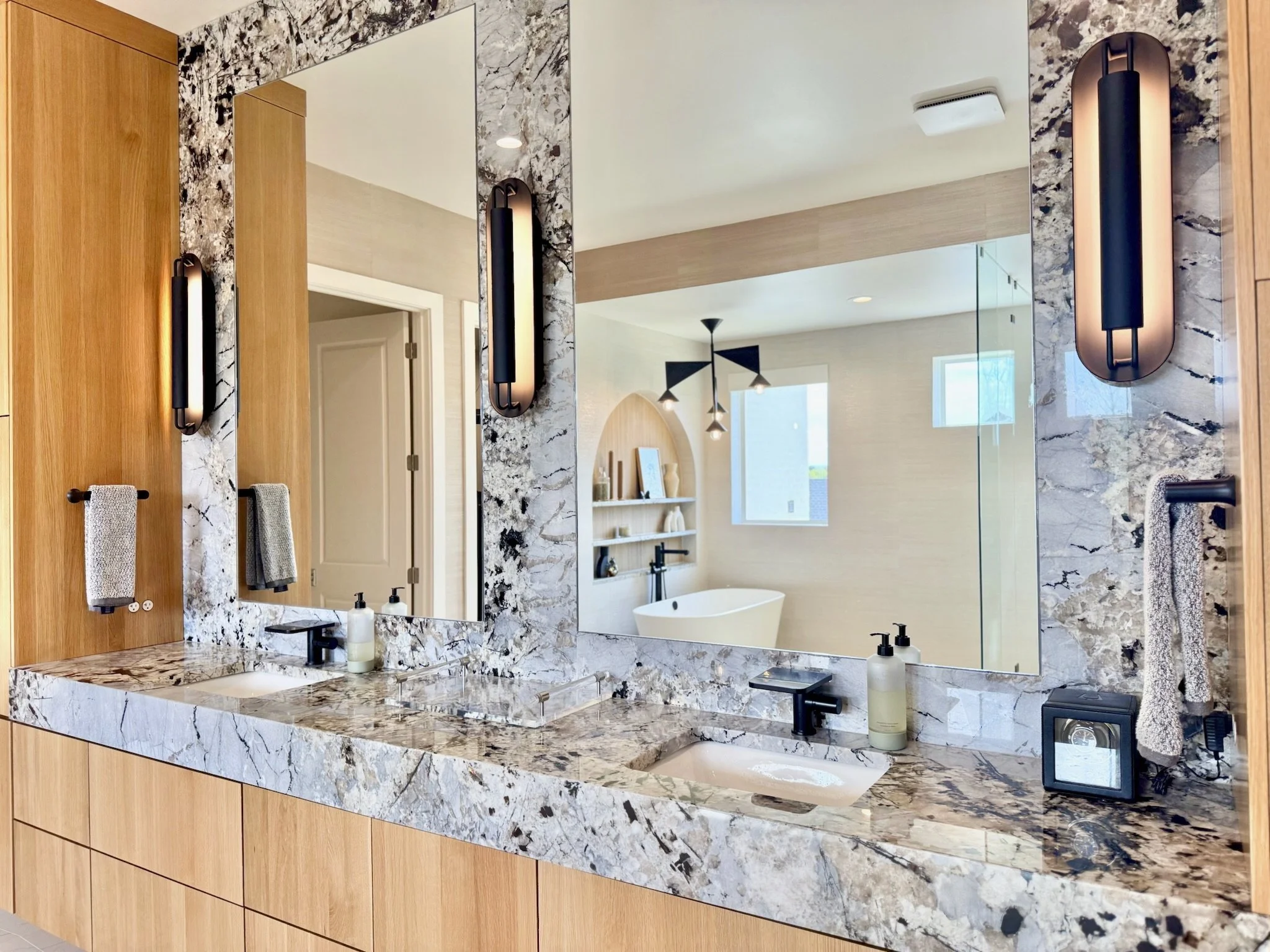 Illuminating Sconces – Flanking mirrors to bring balance and soft light.