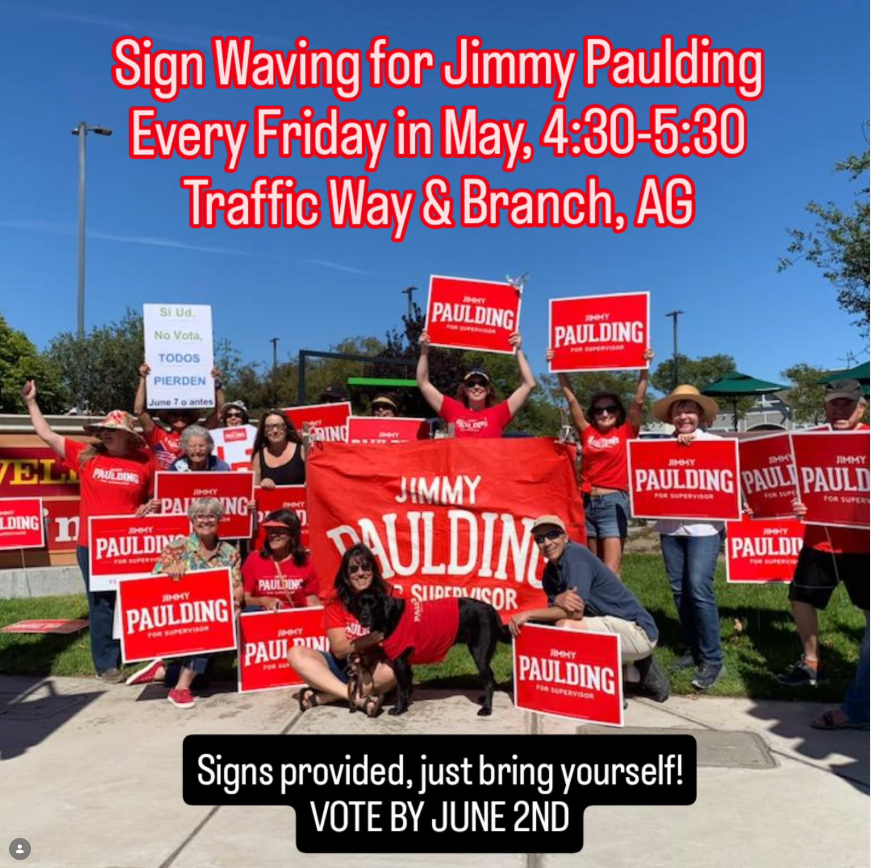 Sign waving for Jimmy Paulding