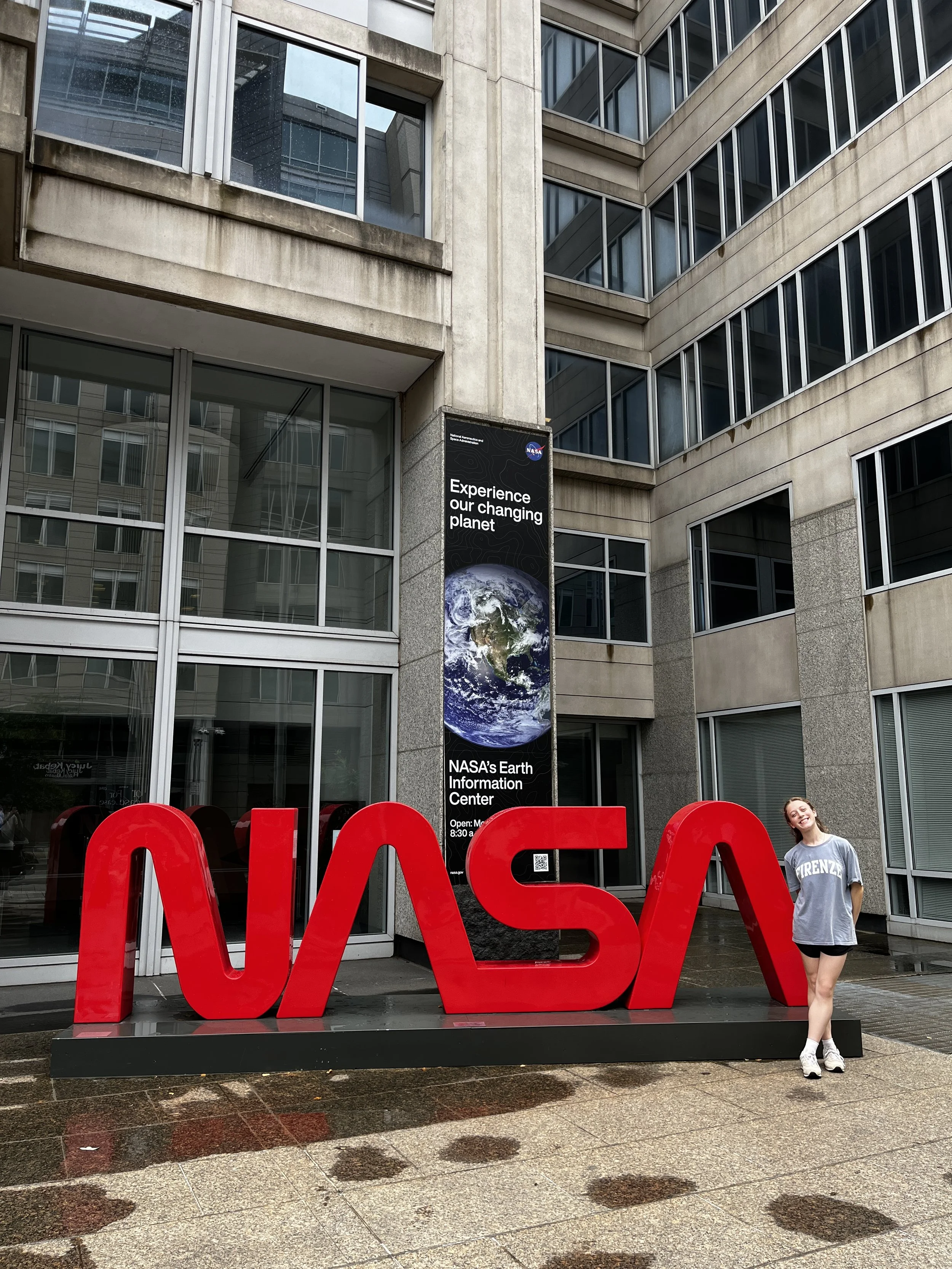 Madelyn standing next to a NASA sign