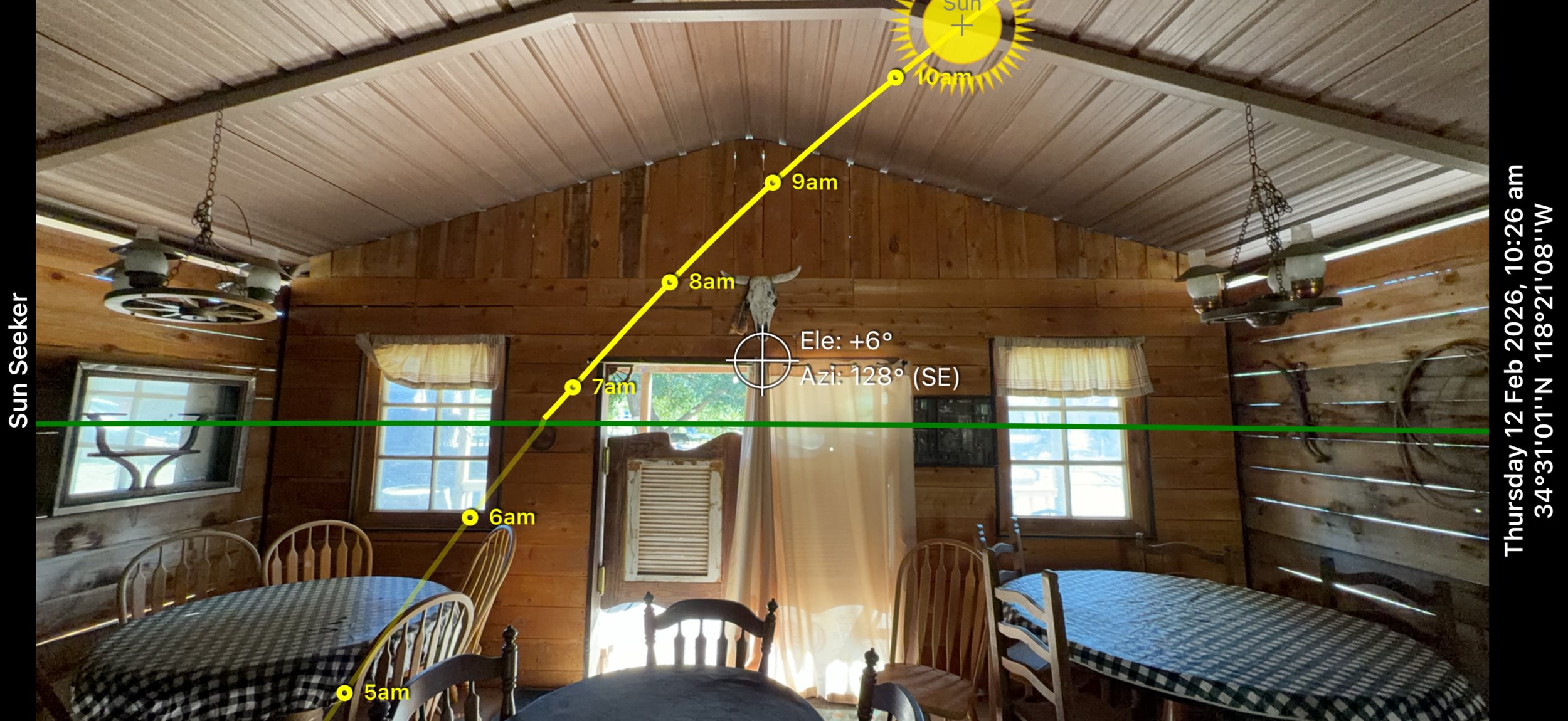 Screenshot from a sun-tracking app plotting the sun's path through the On A Razor's Edge saloon set windows, used by the cinematographer to plan natural light and shadow placement.