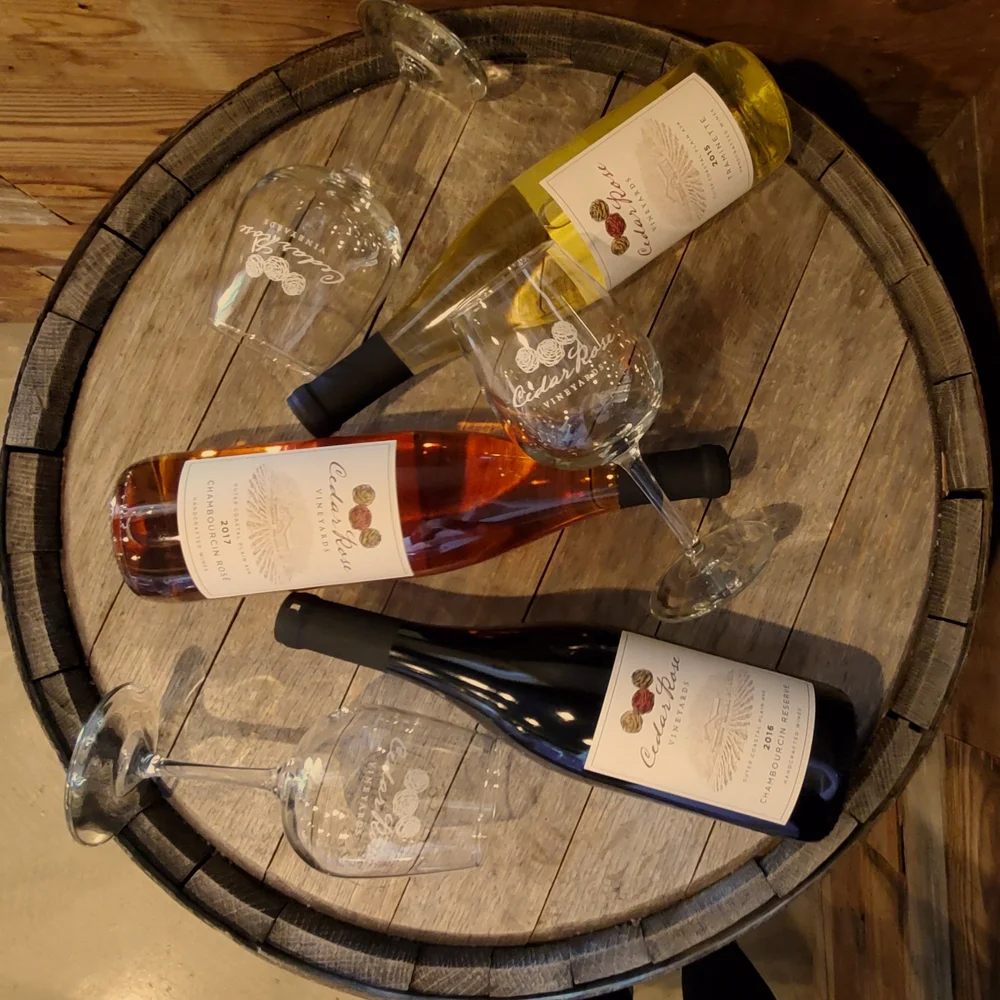 Cedar Rose wines and glasses on a barrel table