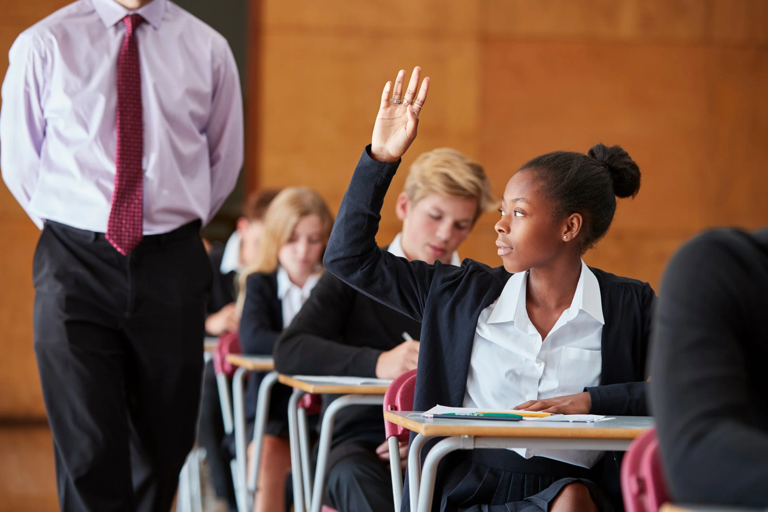a student raises her hand to ask a question