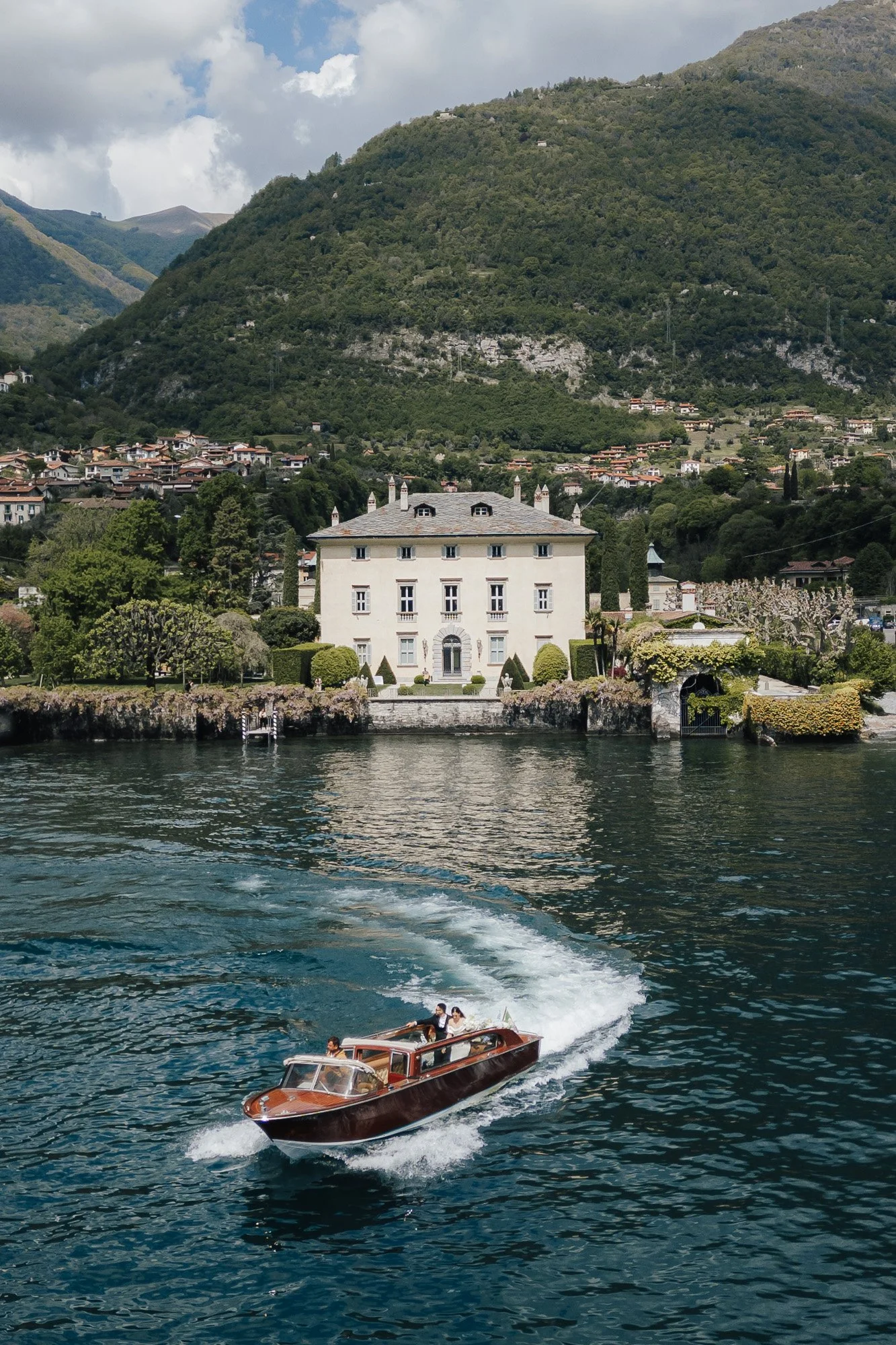 wedding couple on boat in front of villa balbiano lake como