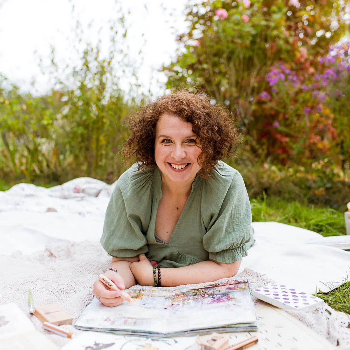 Artist Laly Mille art journaling in her garden.