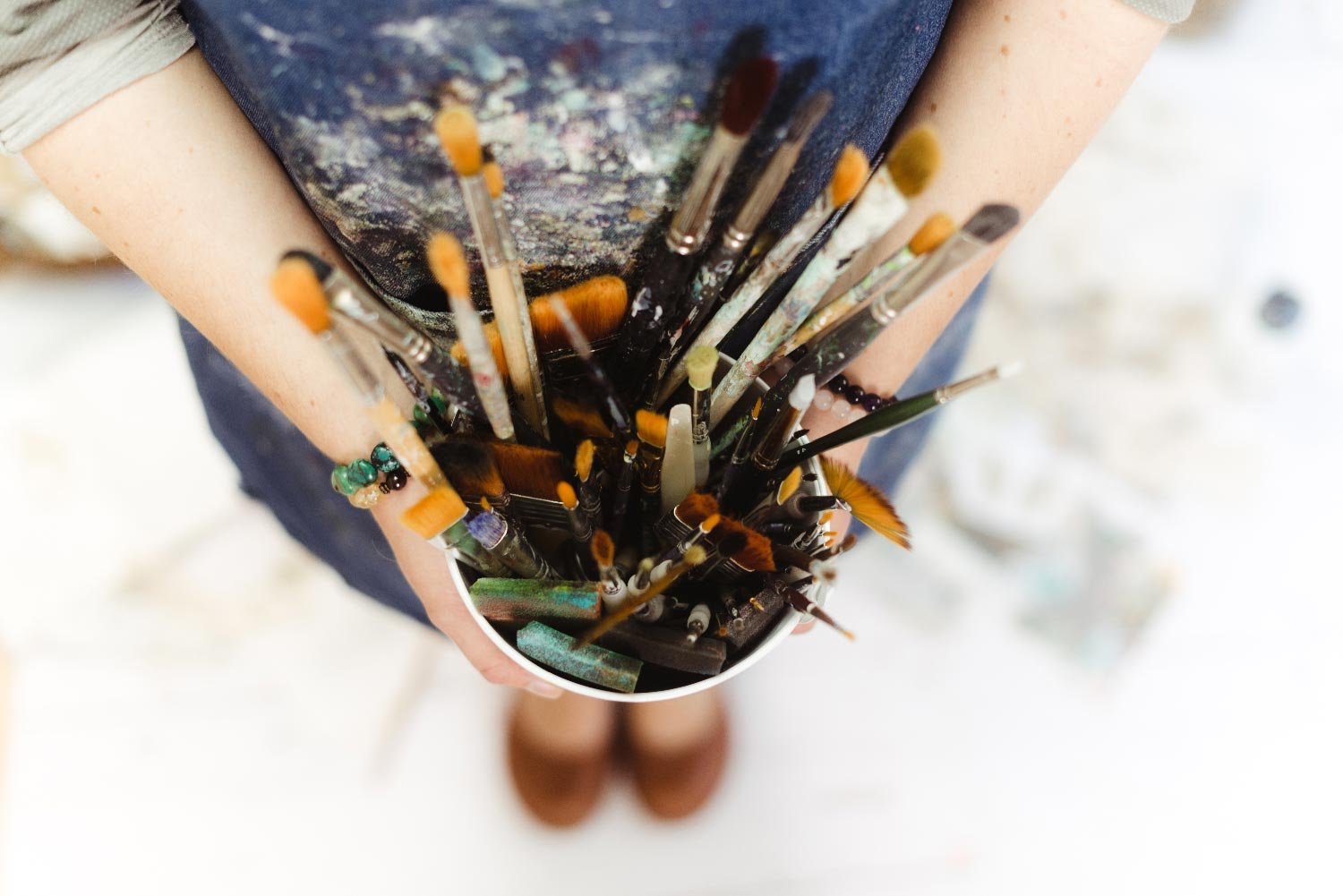 artist holding paintbrushes