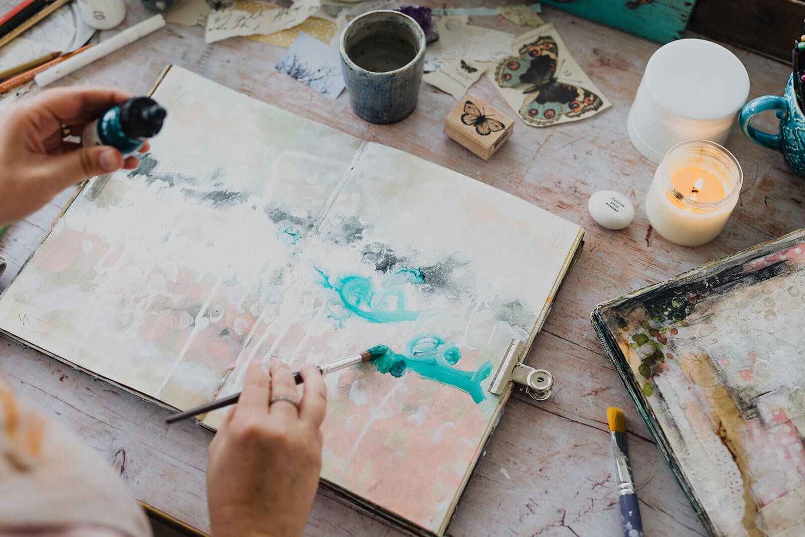 Art journaling with layers of paint and ink at my kitchen island turned art table.