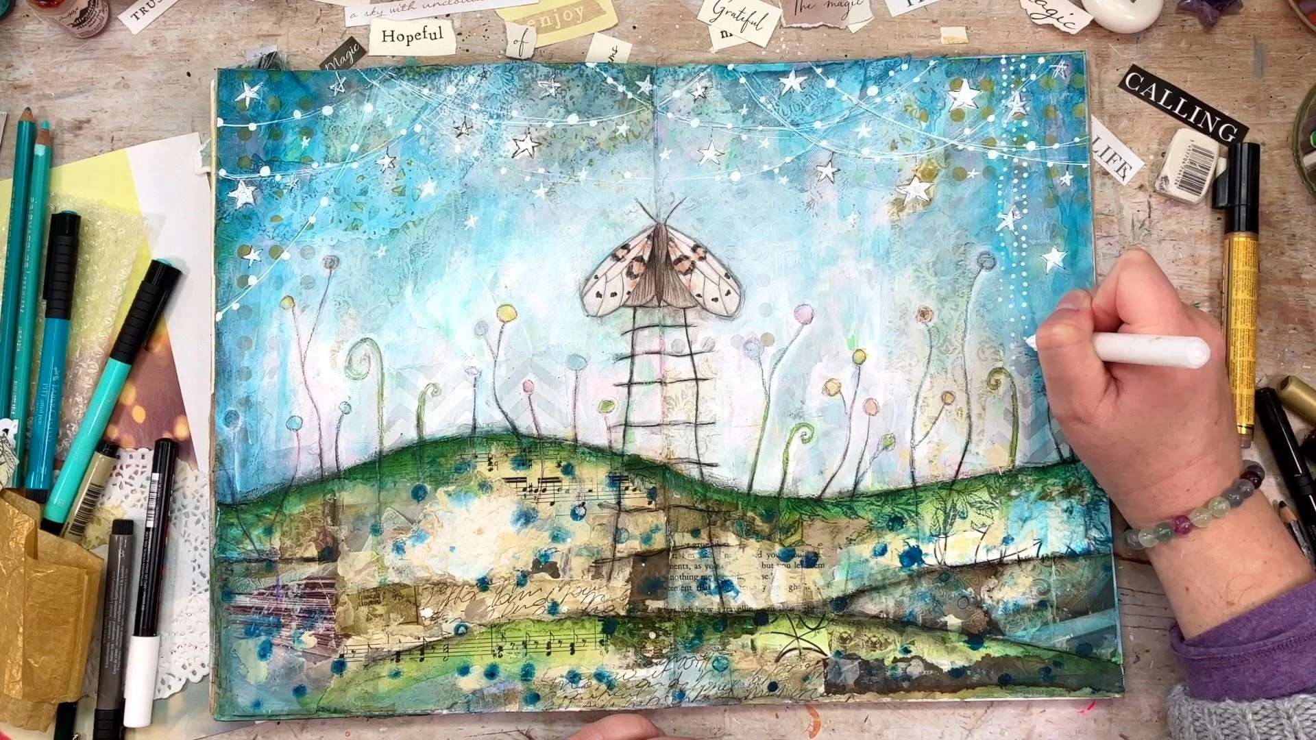 Artist finishing an art journal page