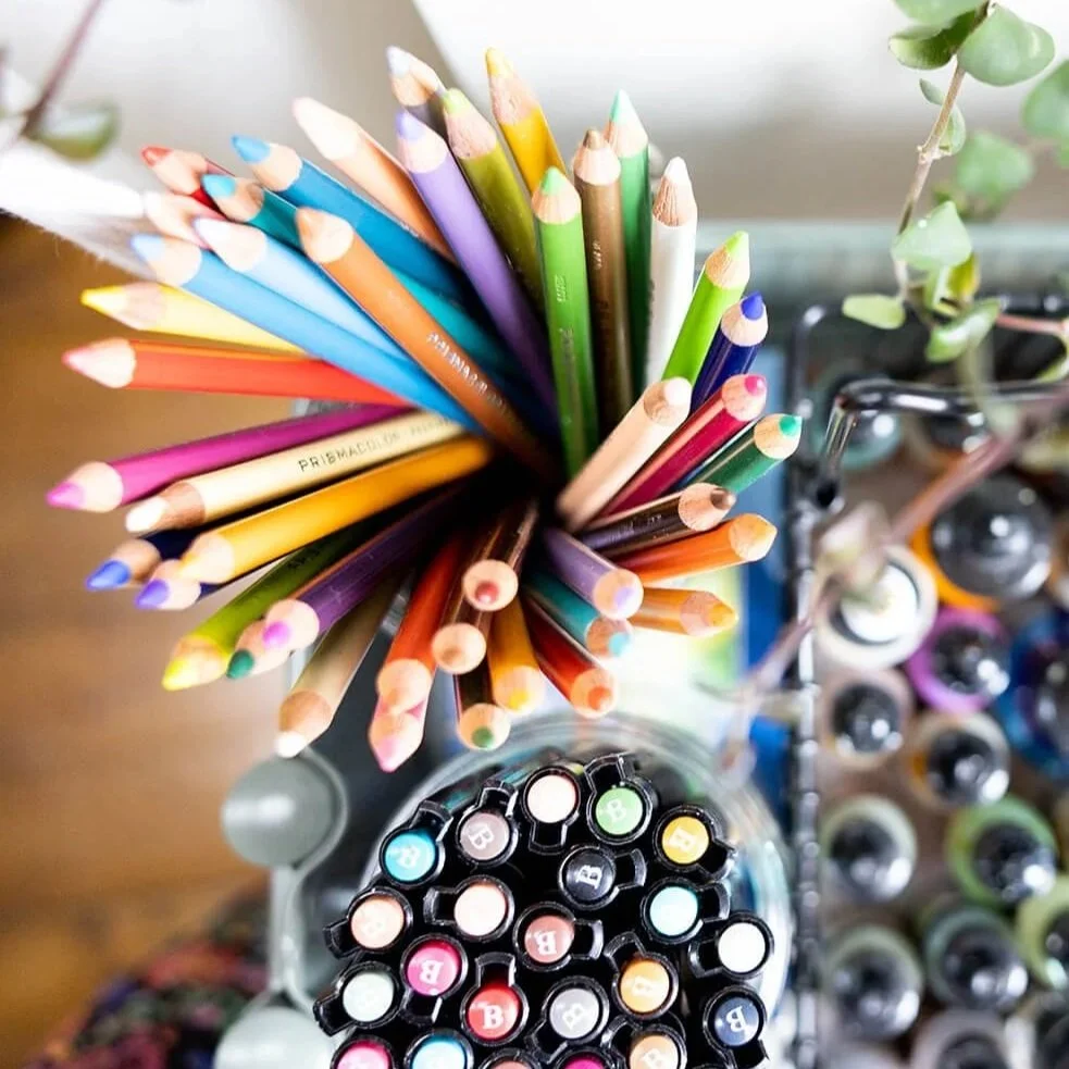 Drawing tools for mixed media art including pencils, pens and crayons.