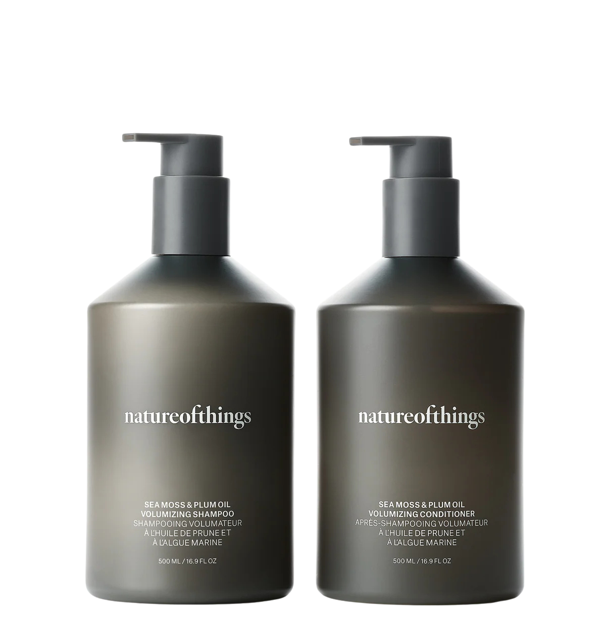 Two black bottles of Nature of Things hair products with white text, one labeled Sea Moss & Plum Oil Volumizing Shampoo, and the other Sea Moss & Plum Oil Volumizing Conditioner, both 500 mL.
