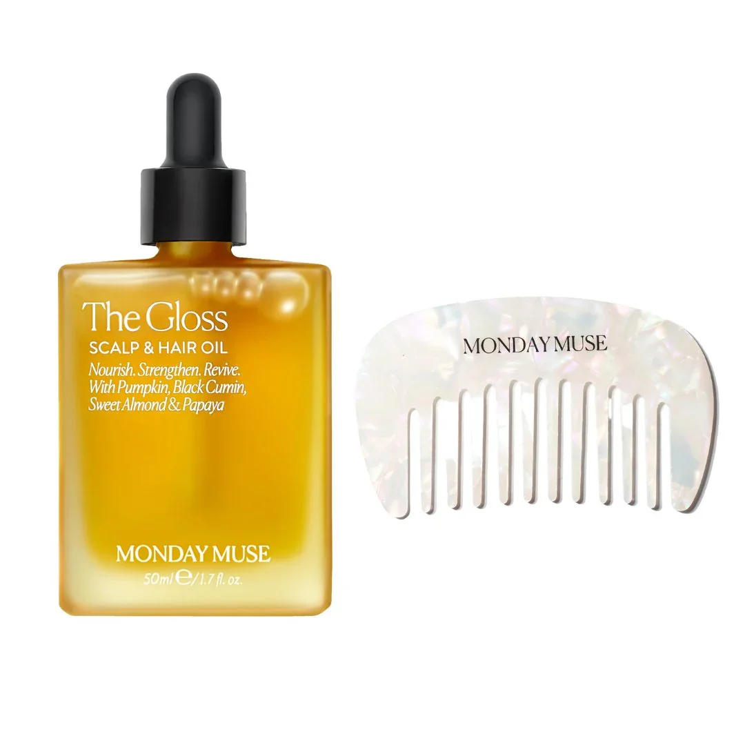 A bottle of The Gloss scalp and hair oil and a pearl-colored hair comb with iridescent sheen, labeled 'Monday Muse' and 'Monday Muse' respectively.