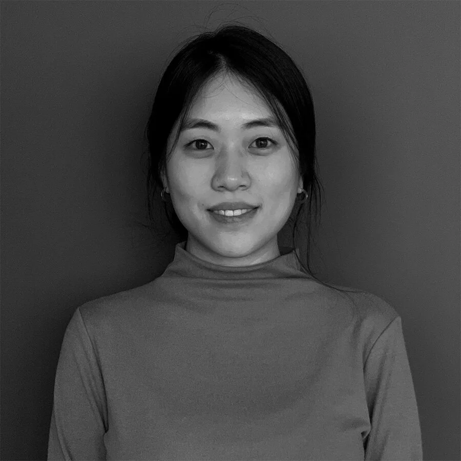 A portrait of emily baik in black and white