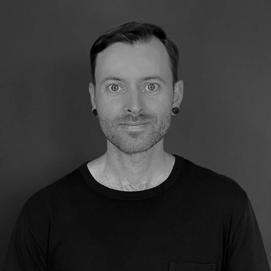 A portrait of Jordan Maddox in black and white