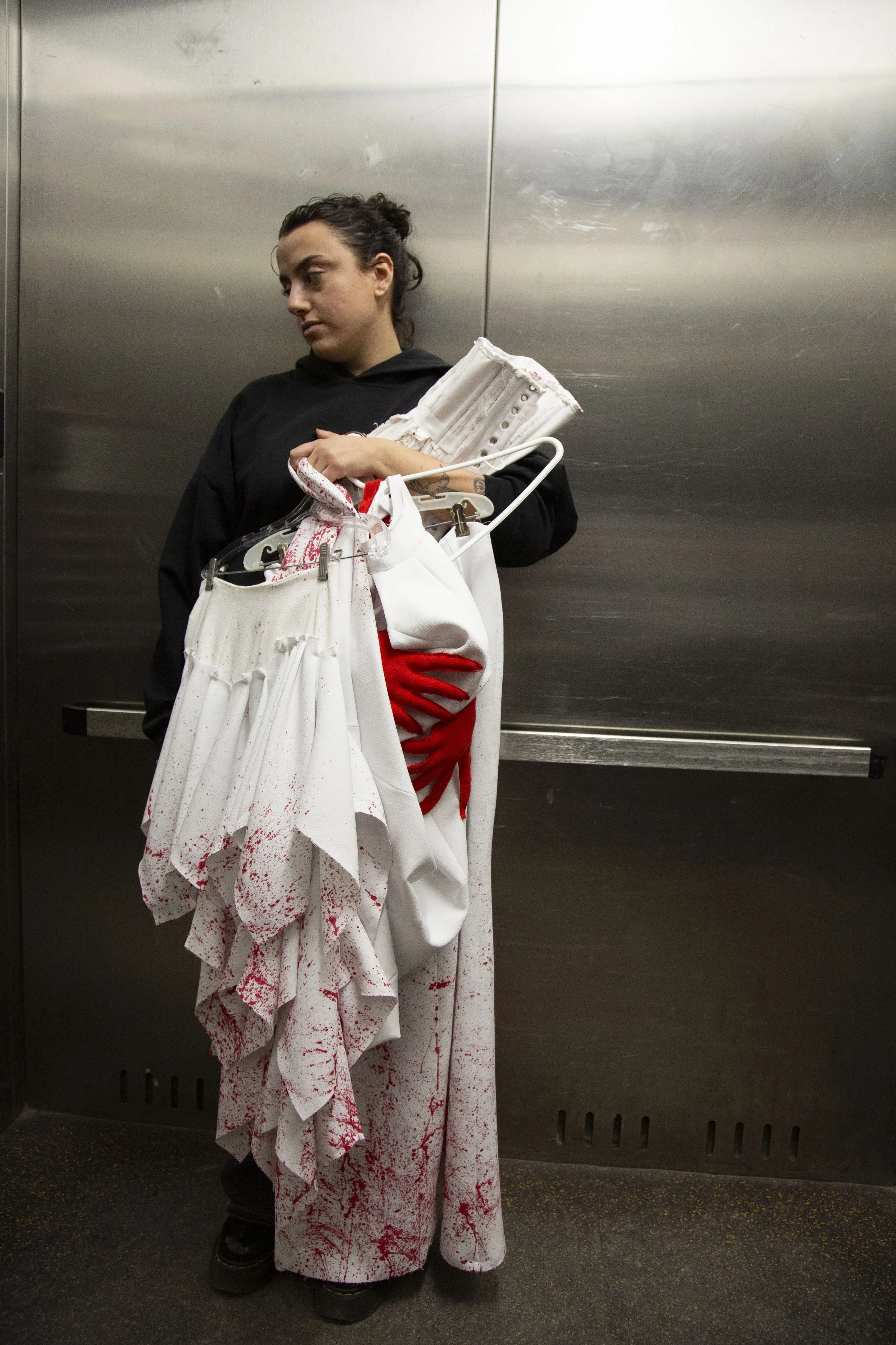 7.	Layla in the elevator after splatter painting her senior collection. After grappling with the future of her academics, she decided to switch to Fashion Design. A Decision that would require a full extra year of college to conform to the program’s 