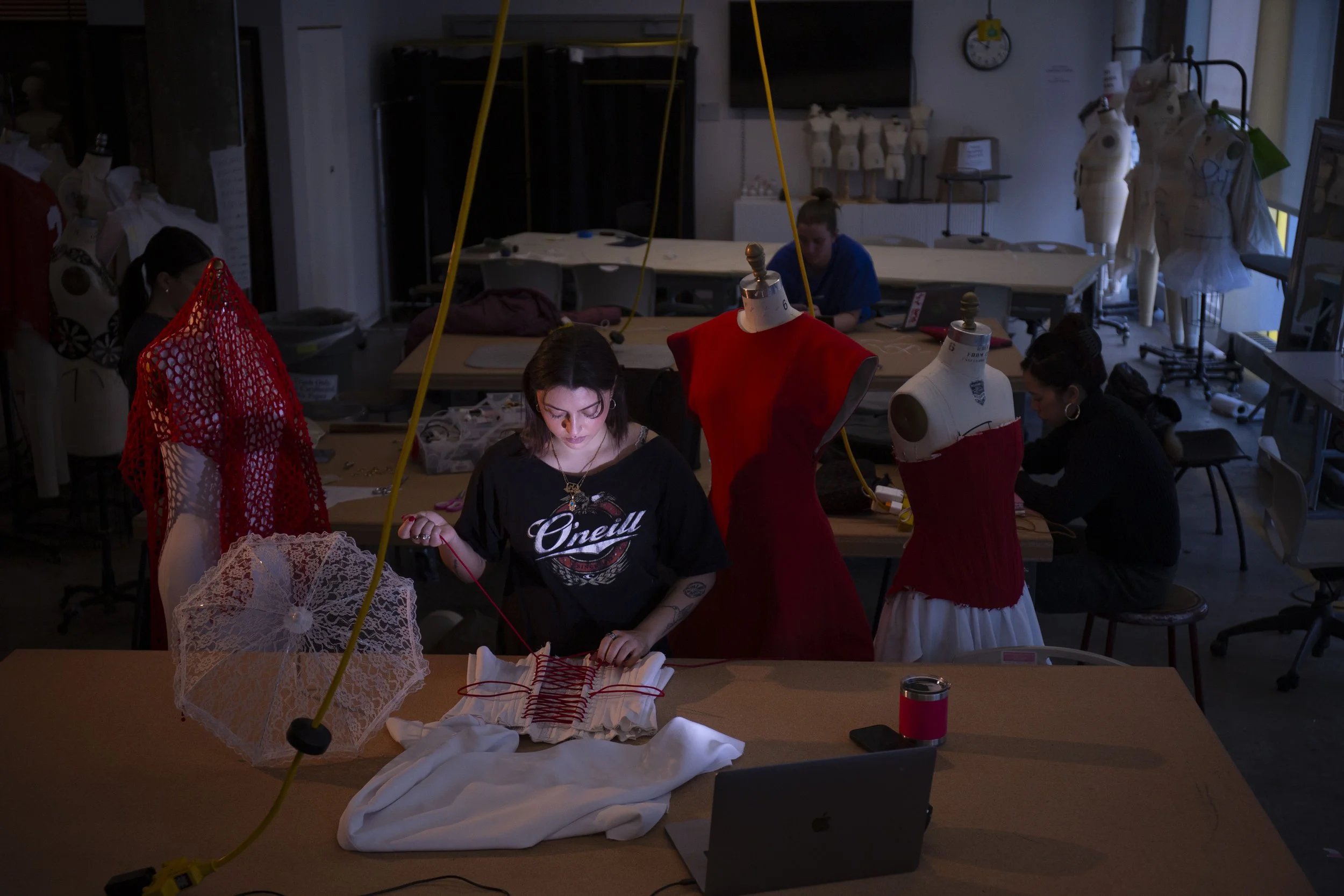 2.	Layla Abudayeh laces up the corset that will adorn the 4th look in her senior collection, WALK EM’ DOWN.