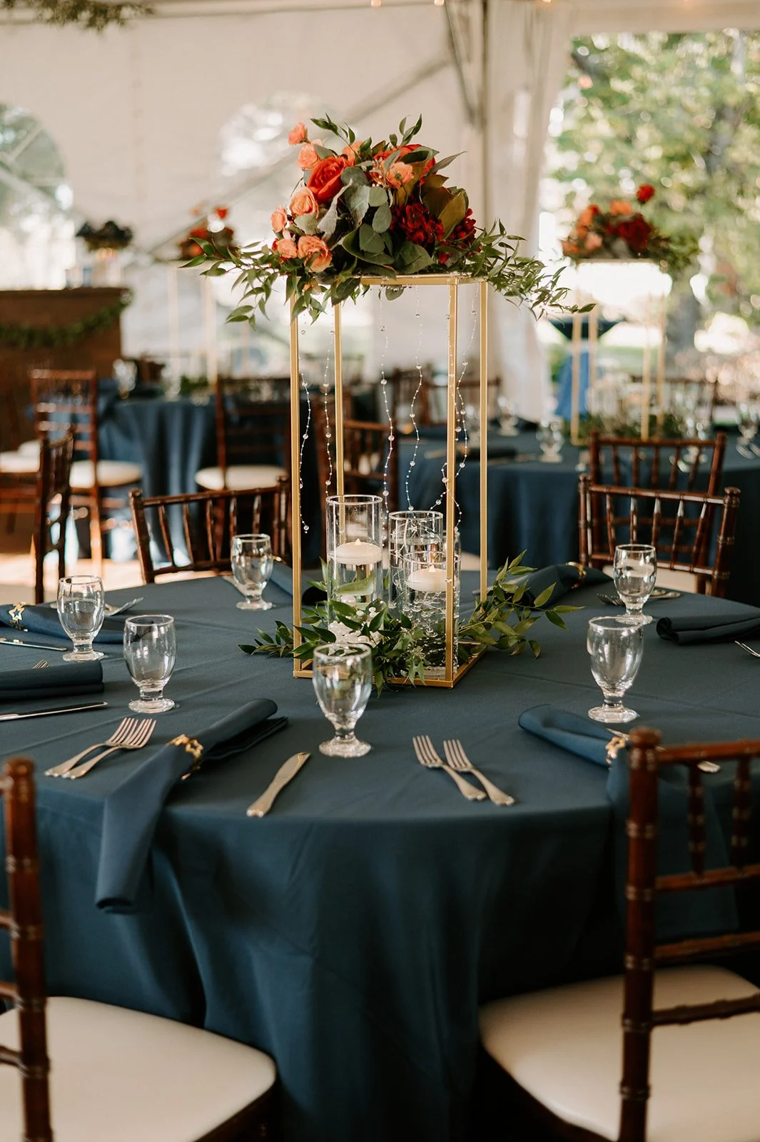 table decor at outdoor wedding venue with tent