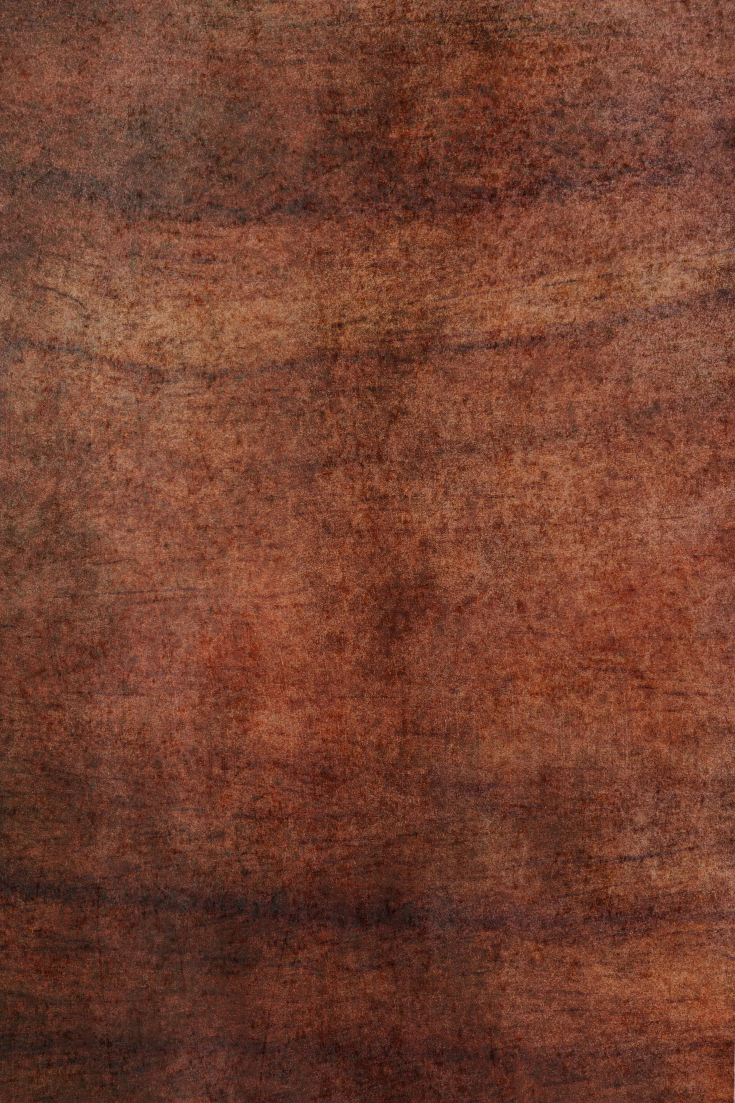 Close-up view of a wooden surface with a reddish-brown color.