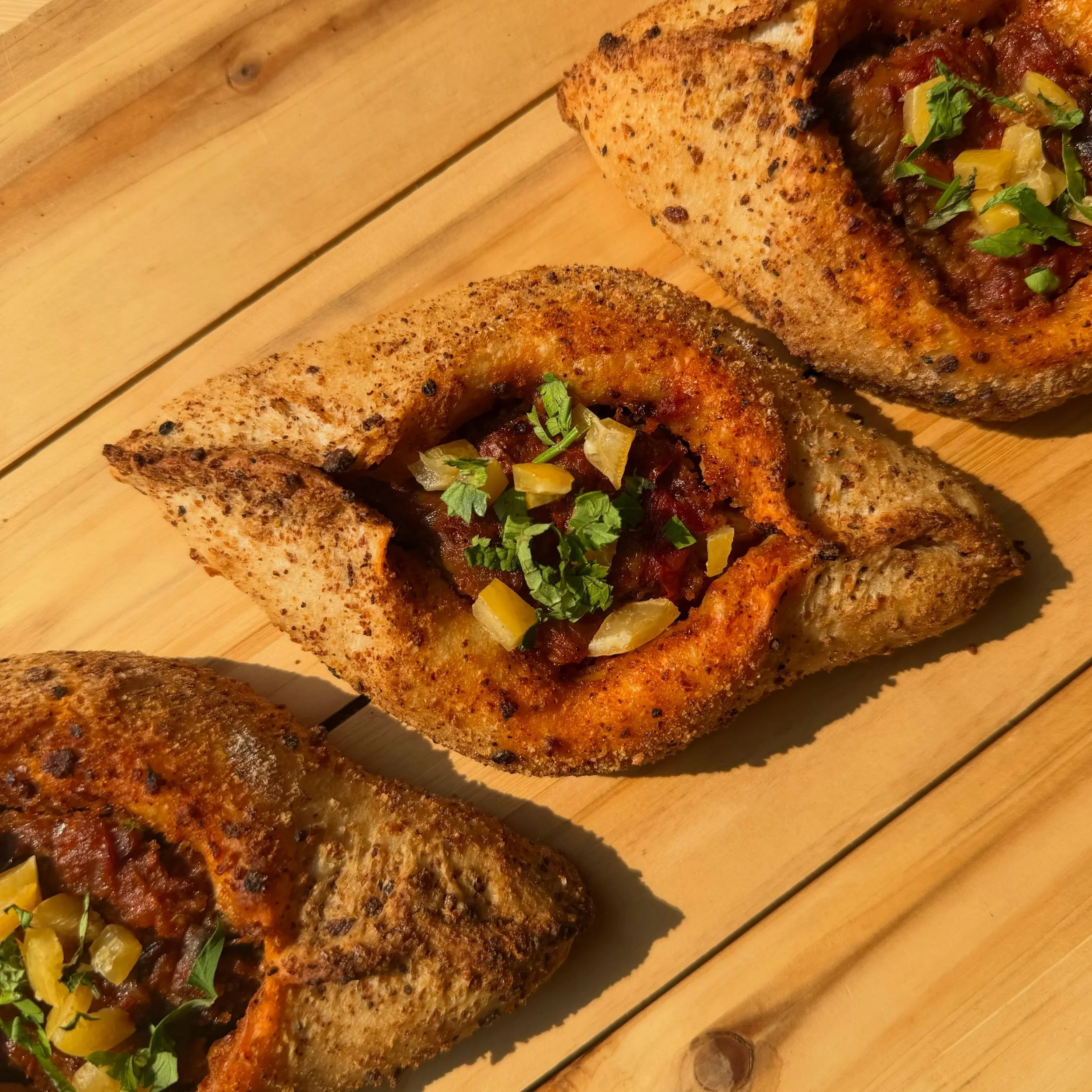 Eggplant Harissa is BACK !!! 

This one was a big hit last year and we had to bring it back! 
Beautifully roasted eggplants, mixed with onions, tomatoes and a beautiful garlicky house made harissa. All topped with preserved lemons and herbs. 

More o