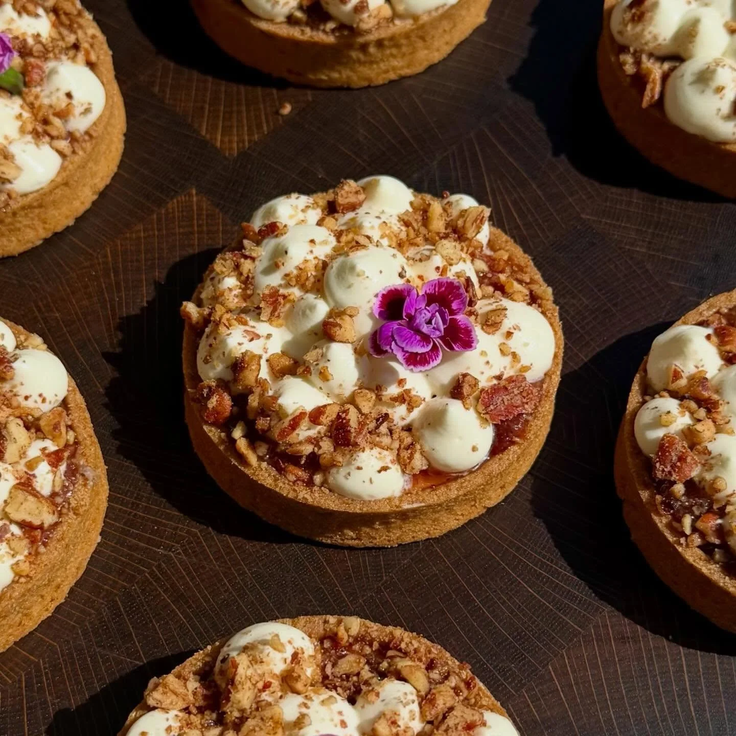 Rhubarb Labneh Tart 🌸 
Nothing makes me happier than rhubarb season. 
This tart has some toasted pecan, rich labneh white chocolate cremeux, and roasted rhubarb jam, all topped with whipped pabneh, more pecans, and a beautiful flower. 
.
.
.
.
.
.
#
