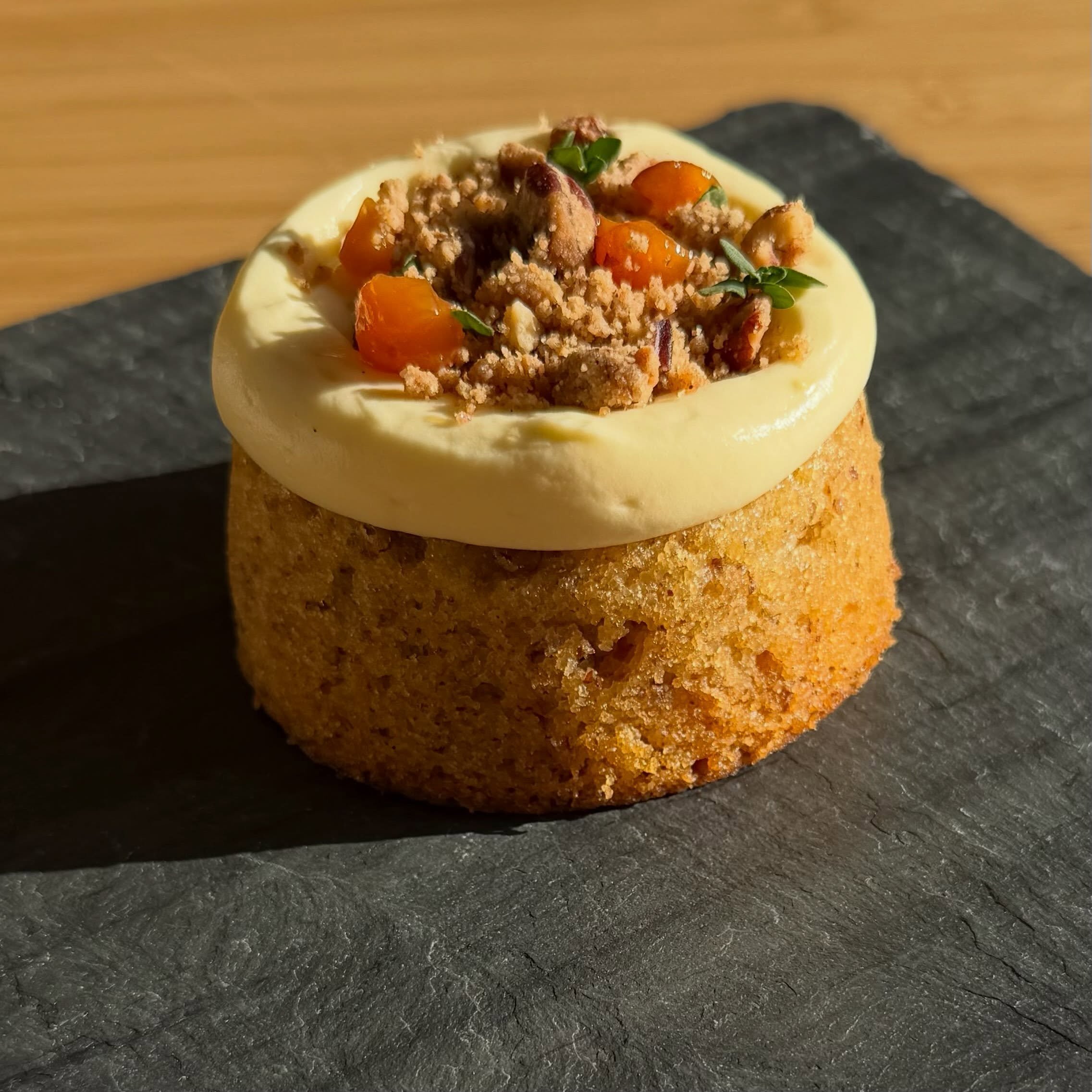 Peaches and cream pecan torte glowing in the sun 🍑!!! 

Pecan torte filled with roasted peaches compote, topped with whipped mascarpone custard and roasted barley streusel. 
.
.
.
.
.
#majdalbakery #middleeasterncuisine #dessert