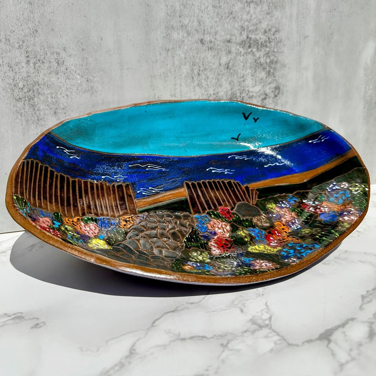 How&rsquo;s this for a dream view? Floral garden path leading to the sea. 🌊 🌸 ☀️ 

I made canvases out of slab-built oval dishes and decorated them with underglaze painting and carving. 

I&rsquo;m really liking this new shape (basically, mom made 