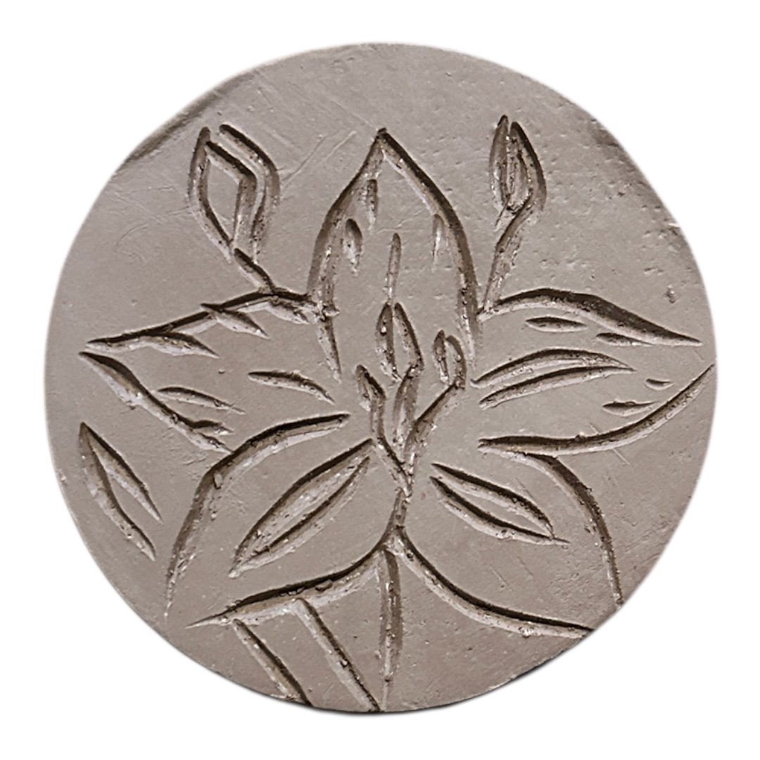 carved flower in clay with diamond core tool by meesh pottery