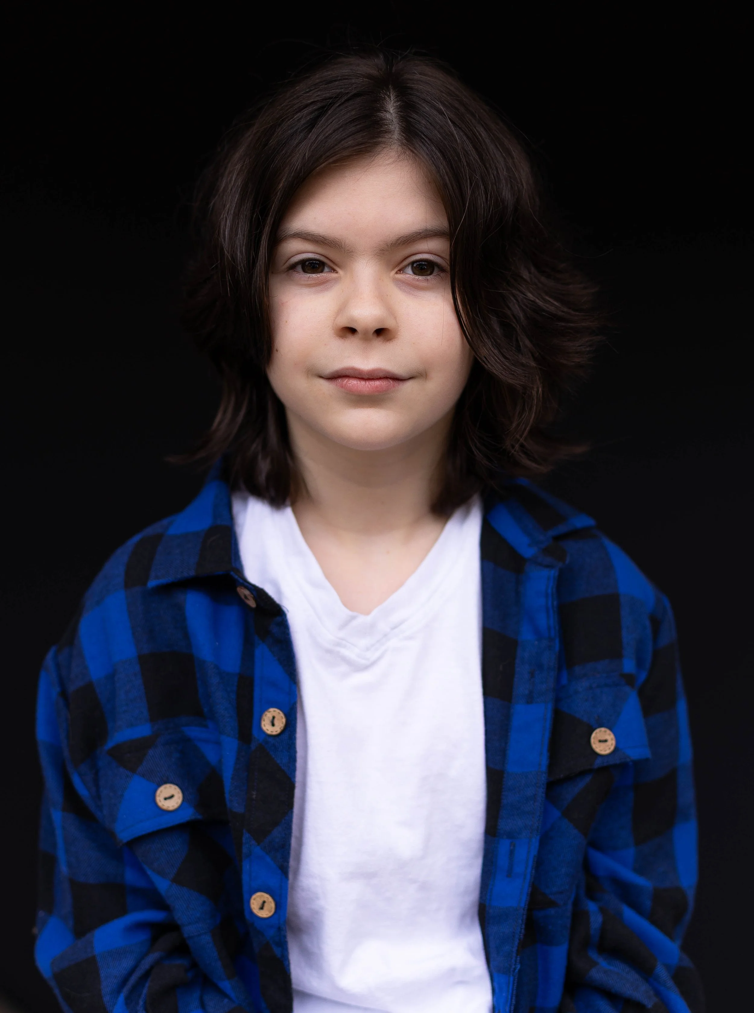 young boy smirking for the camera during school picture day.