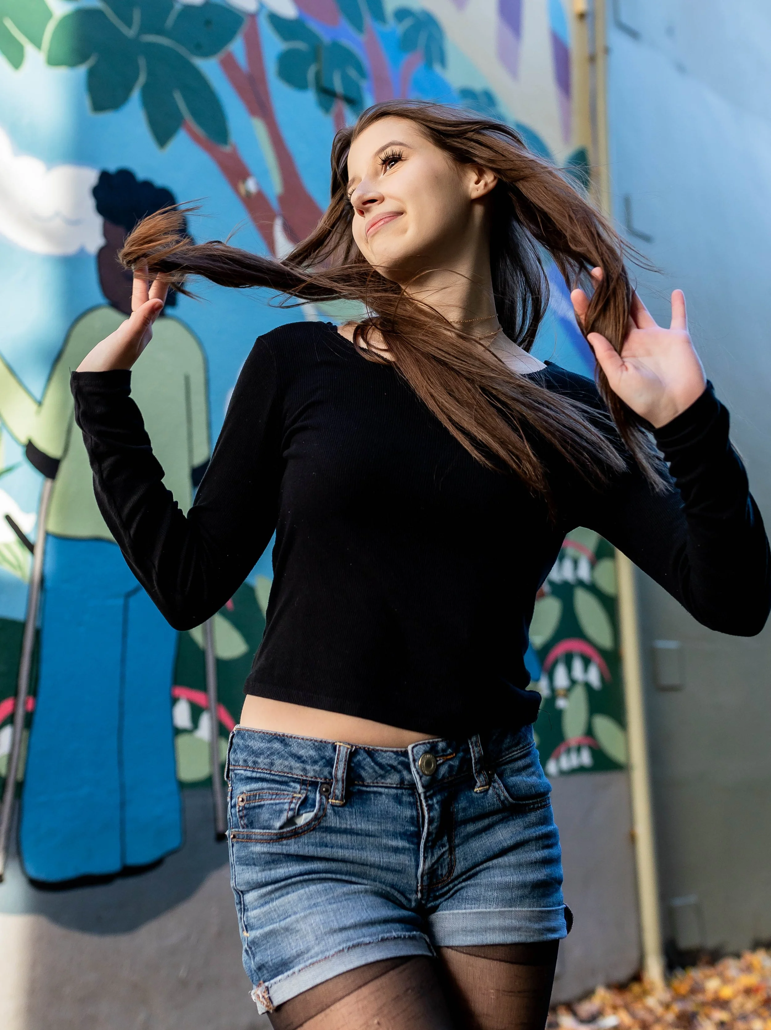 Senior photoshoot in urban downtown Olympia in front of murals.