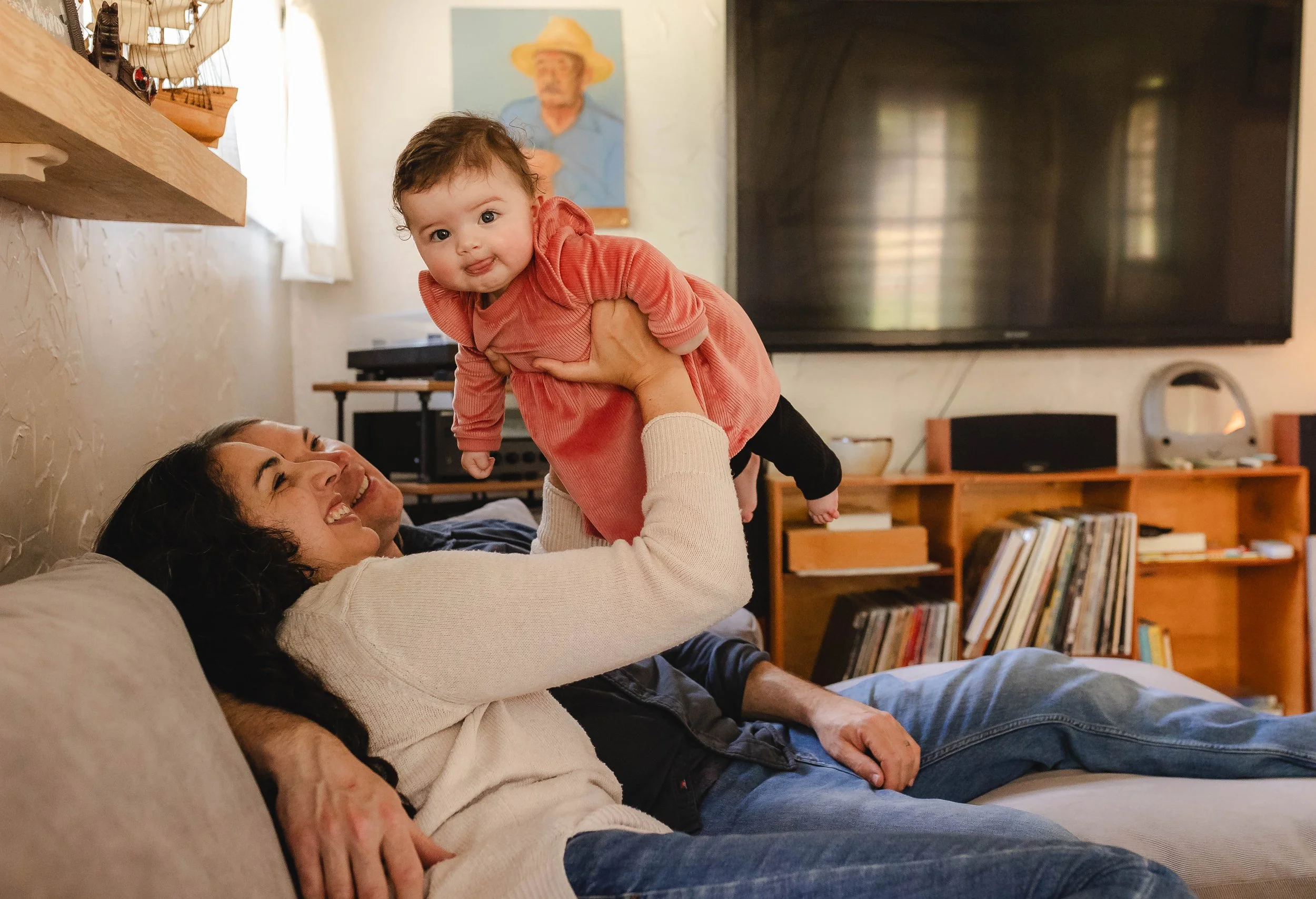 Mom and baby play during family photos in the comfort of their home. Olympia Washington family photographer.