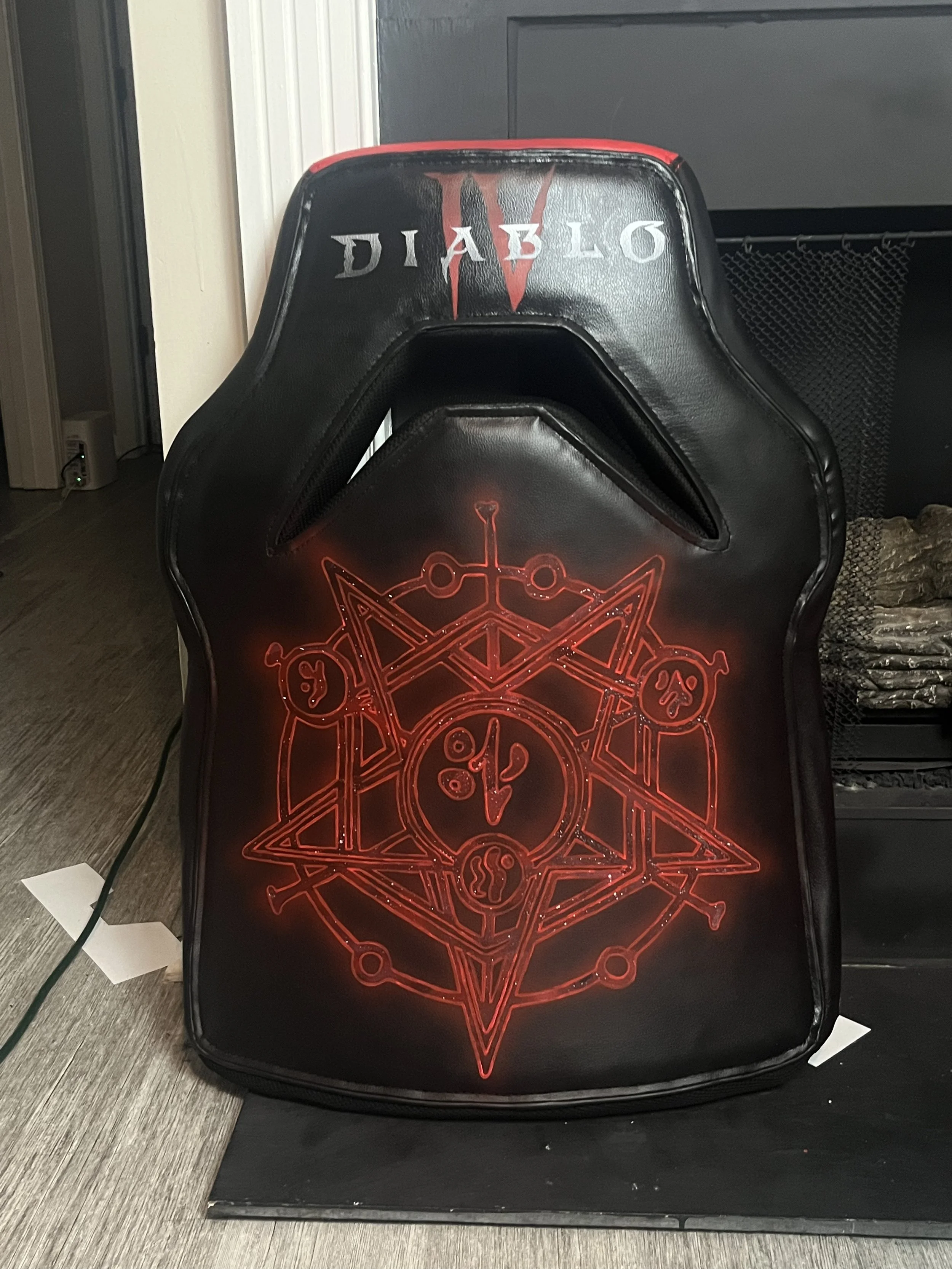 Gaming chair backrest with 'Diablo IV' design and red arcane symbol.