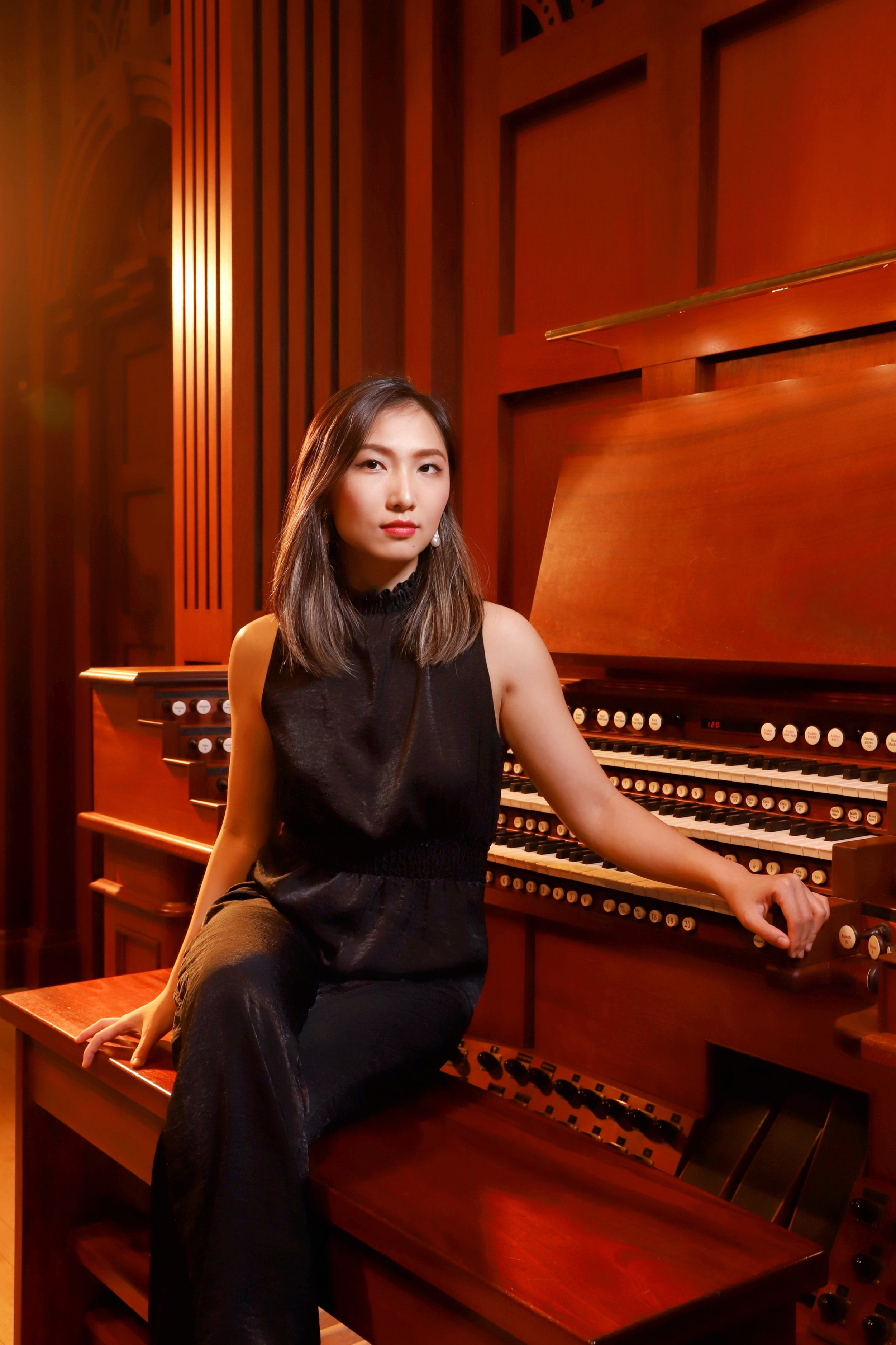 Valentina Huang seated at the organ console at Edythe Bates Old Grand Organ Hall